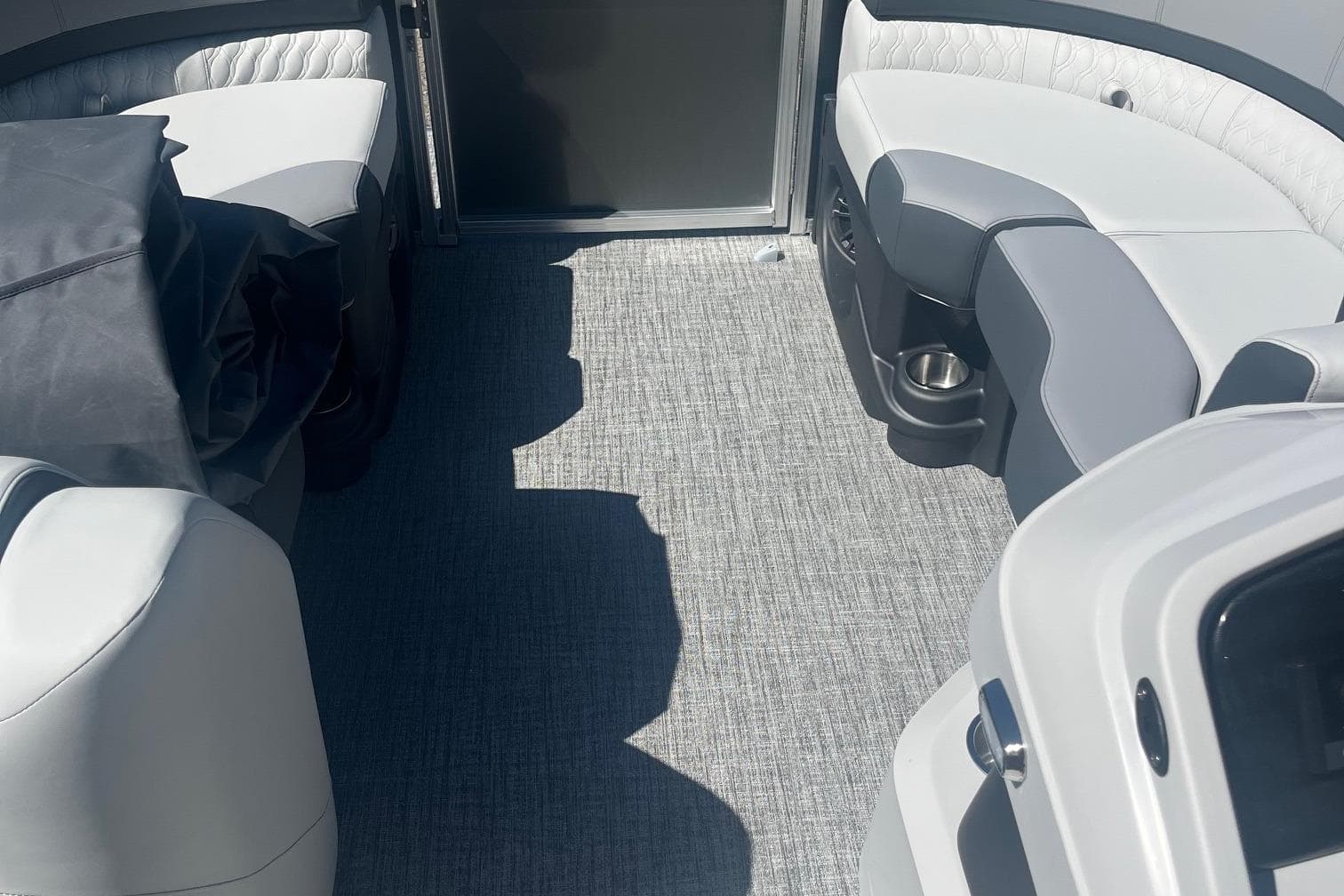 2026 Avalon 23 Quad Lounger interior with gray seating and carpet flooring.
