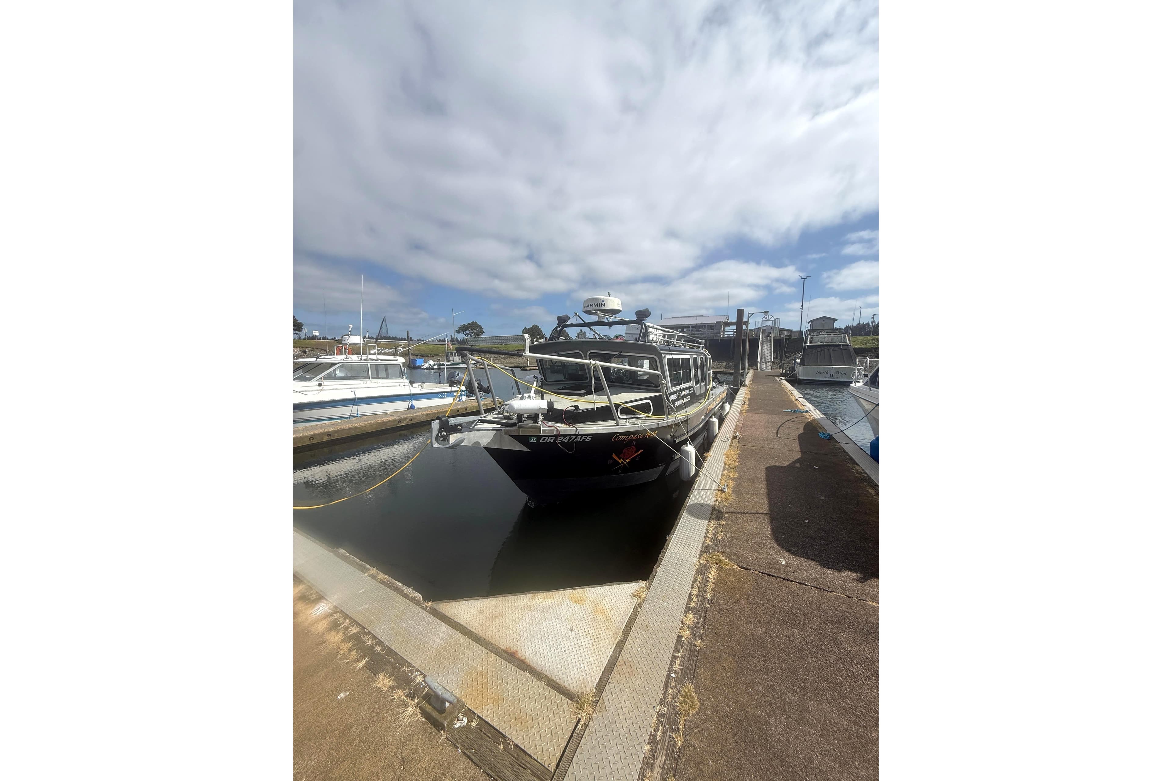 2016 North River 29 OFFSHORE boat docked under cloudy sky.