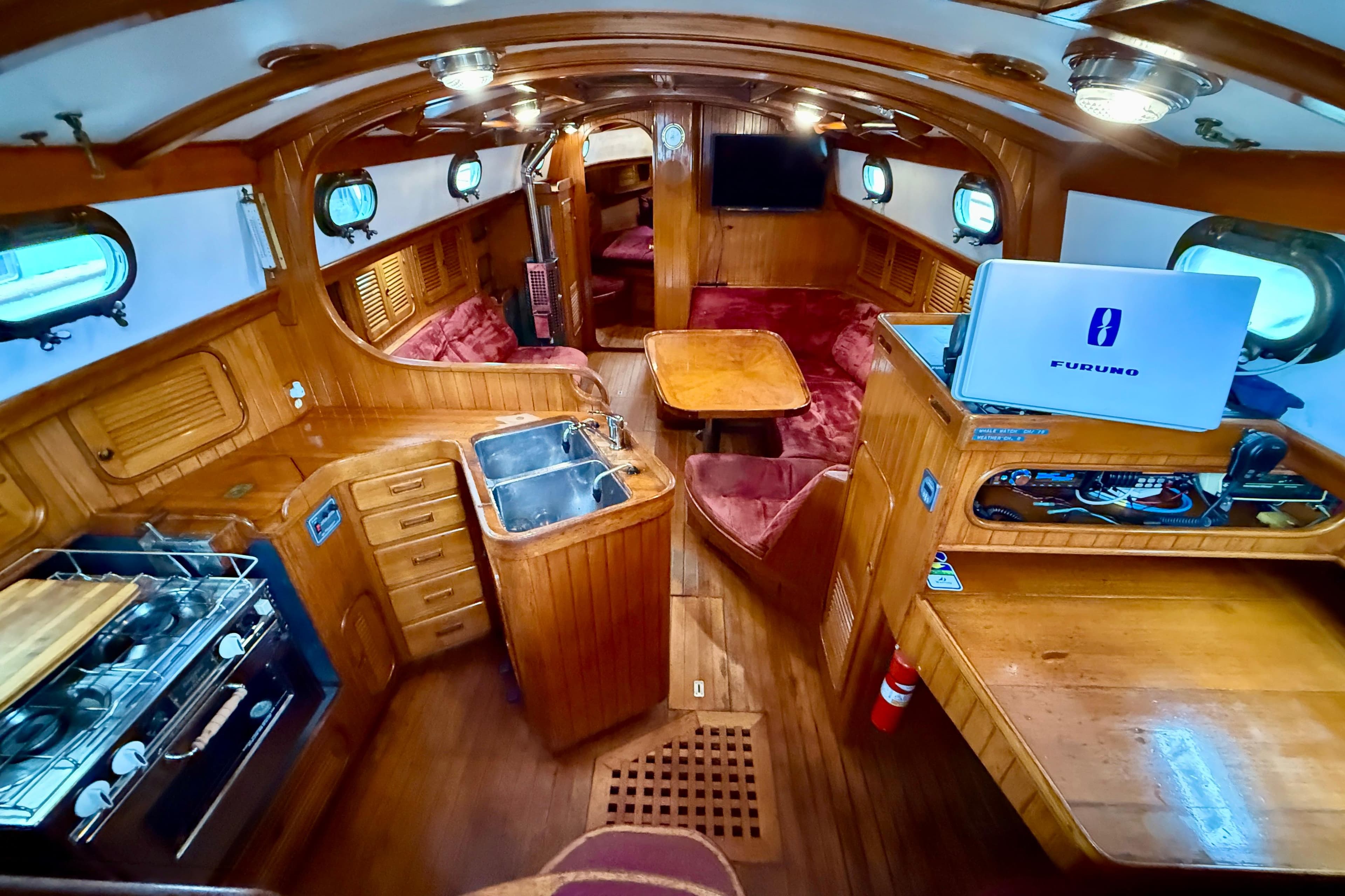 Interior of 1982 Ta Shing Panada yacht with wooden furnishings and modern amenities.