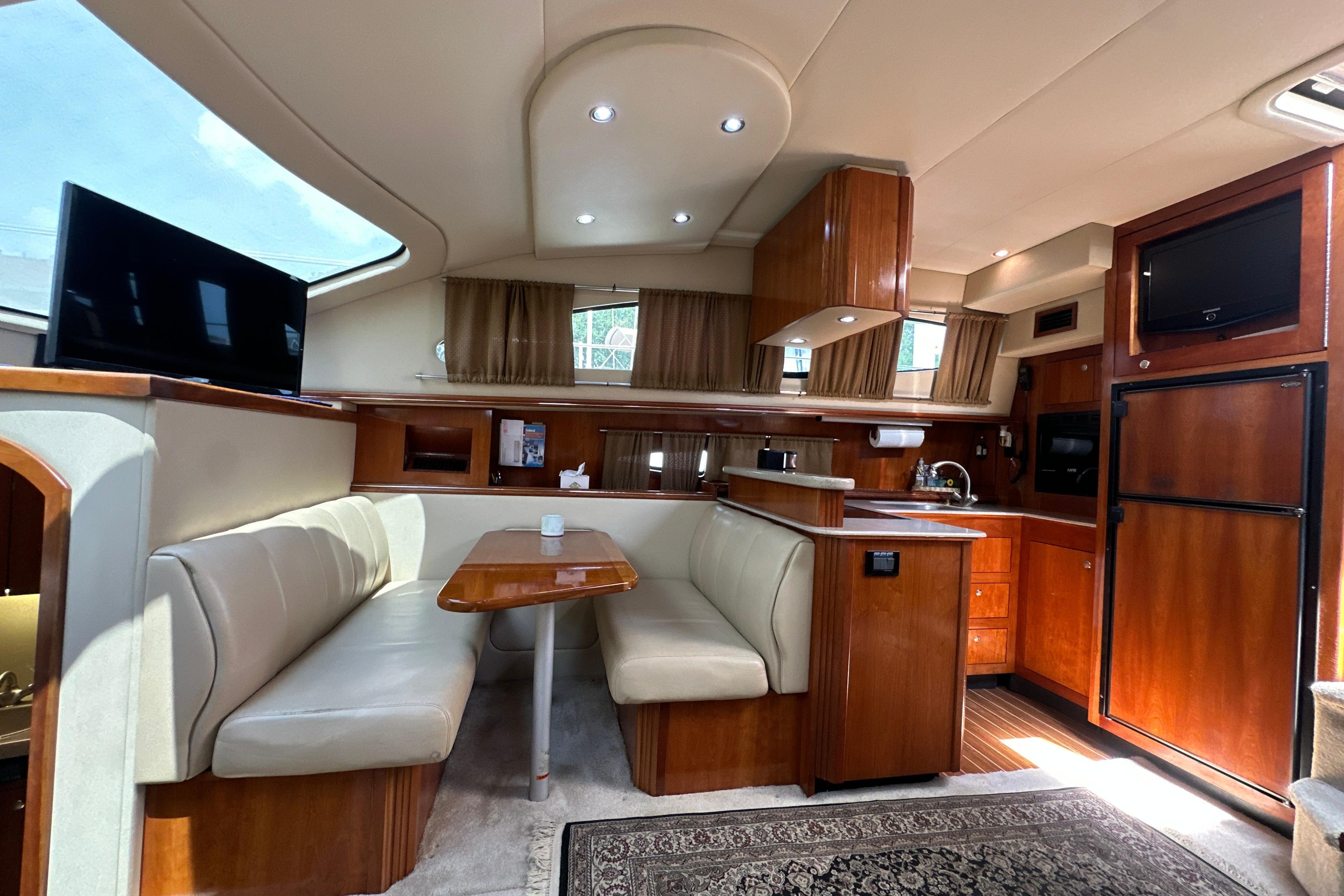 Luxurious 2004 Cruisers Yachts 405 Express Motoryacht interior with elegant wood finishes and cozy seating.