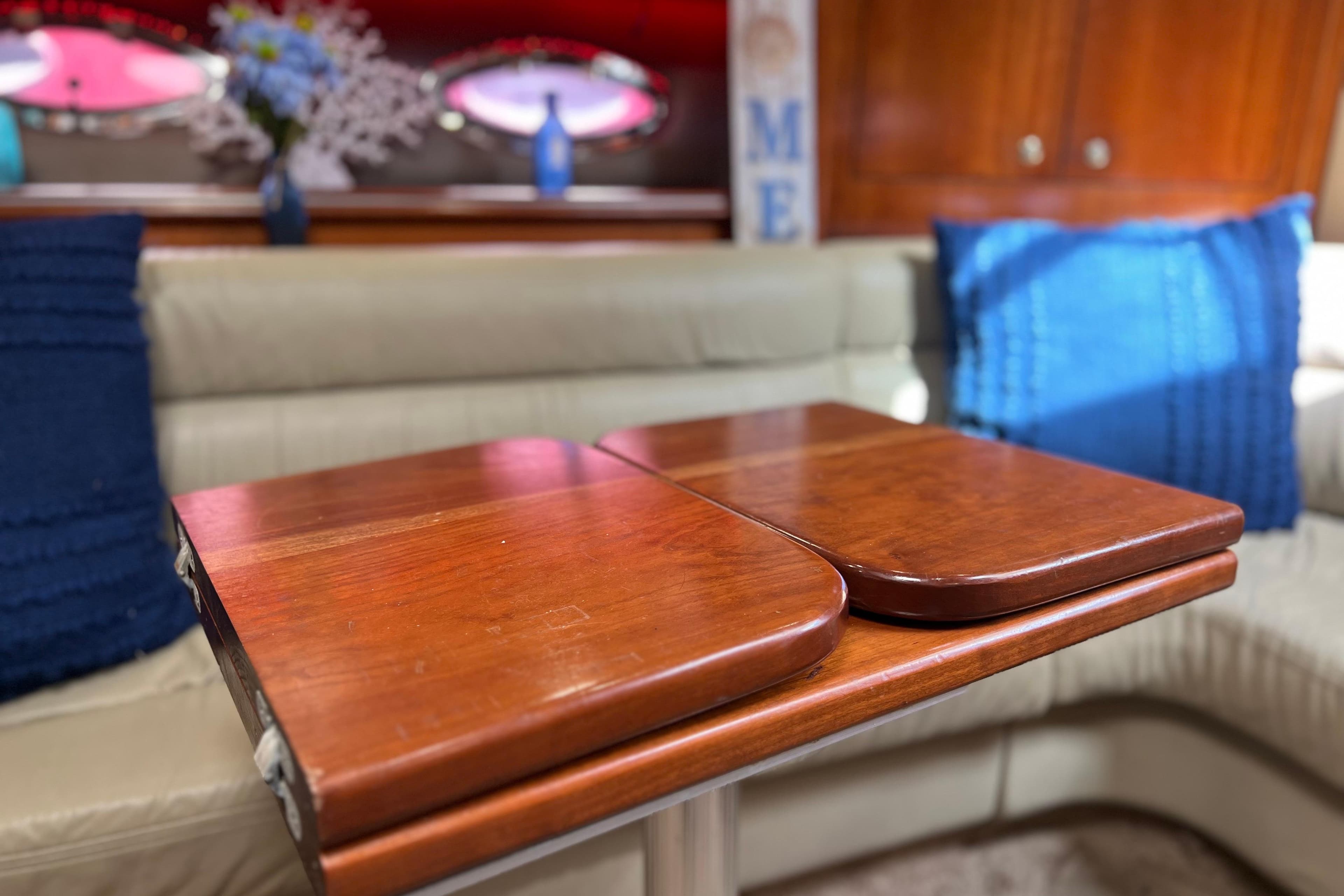 Interior of 2005 Cruisers Yachts 440 Express with wooden table and blue accents.