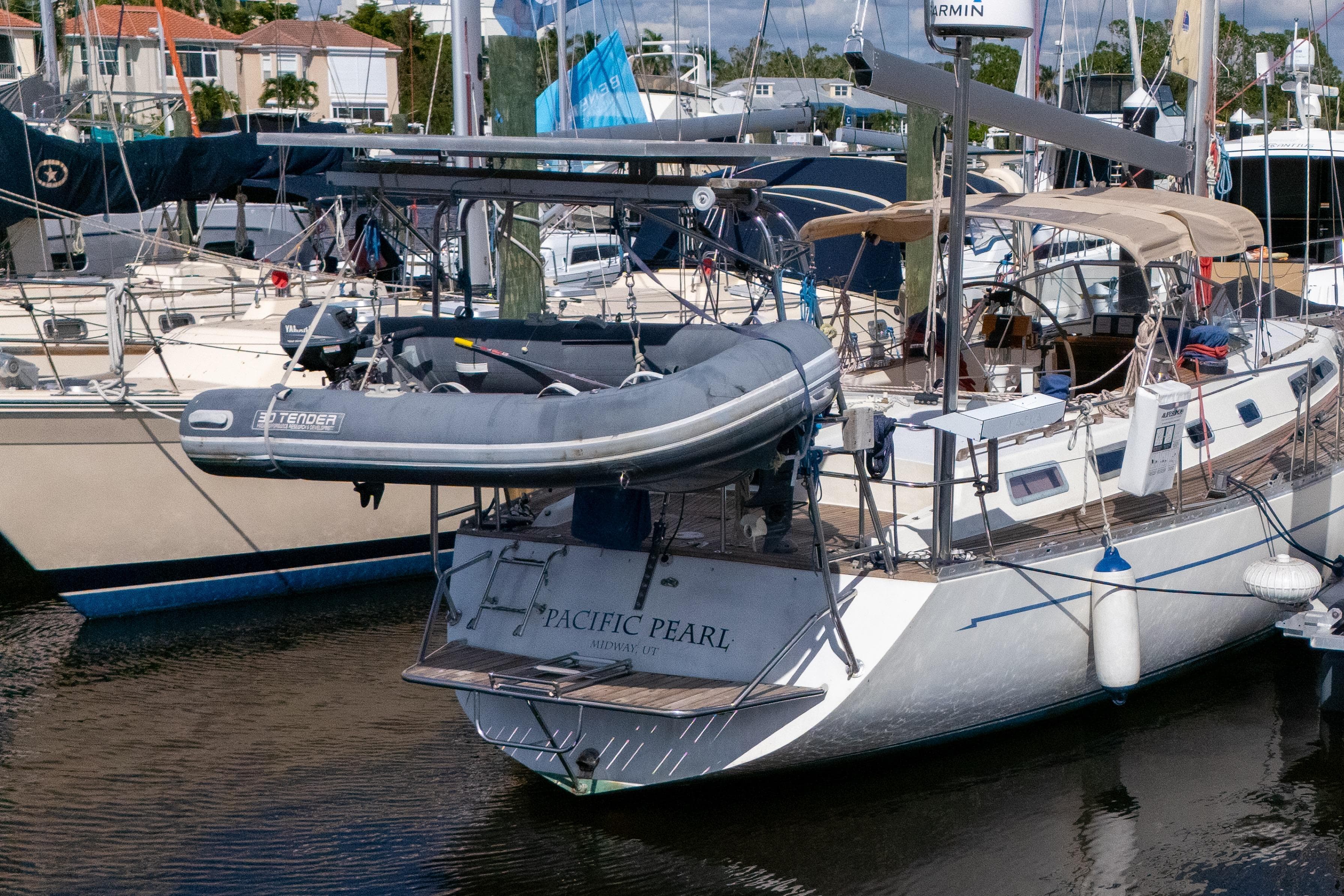 Sailboat "Pacific Pearl" docked, Oyster LW48 model, 1991, with tender boat on deck.