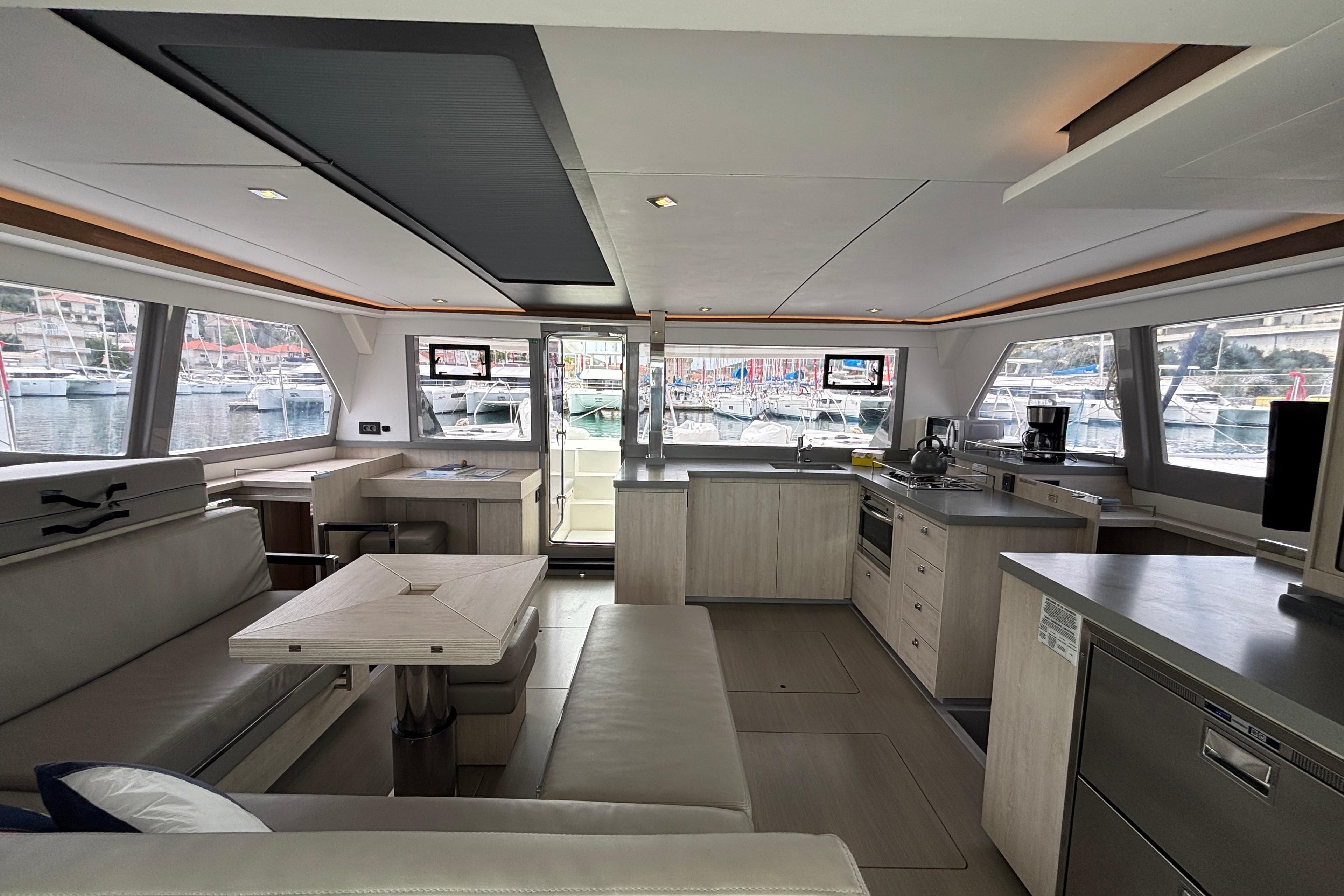 Modern interior of a 2020 Leopard 45 catamaran with spacious seating and kitchen area.