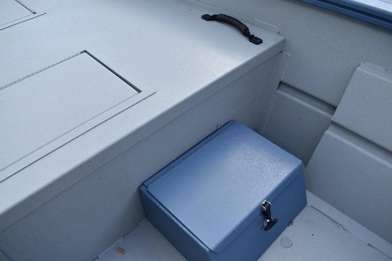 Interior of 2026 Lowe Roughneck RX2070 CC boat showing storage compartments and handle.
