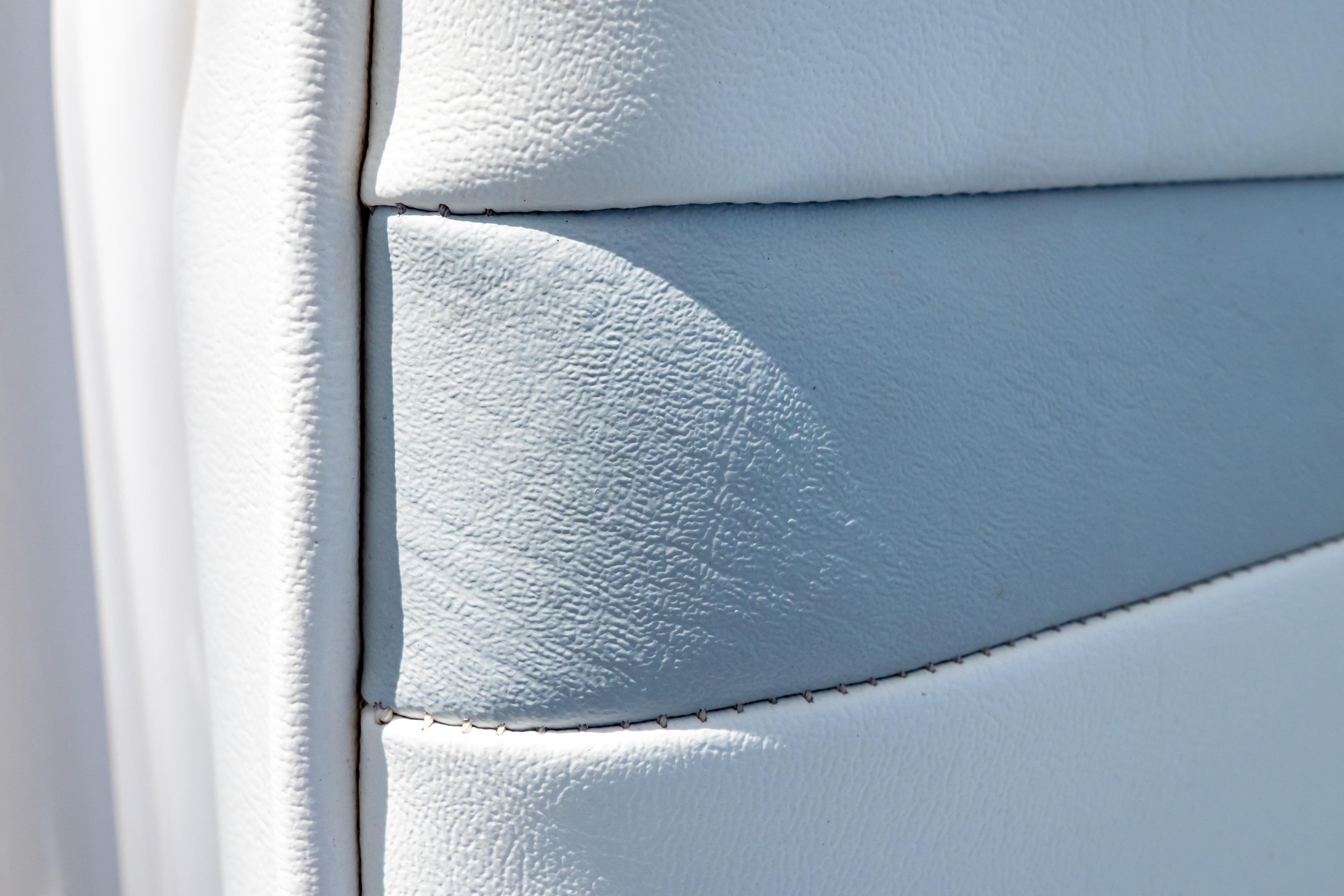Close-up of white leather upholstery on a 2016 Intrepid 400 Cuddy boat.