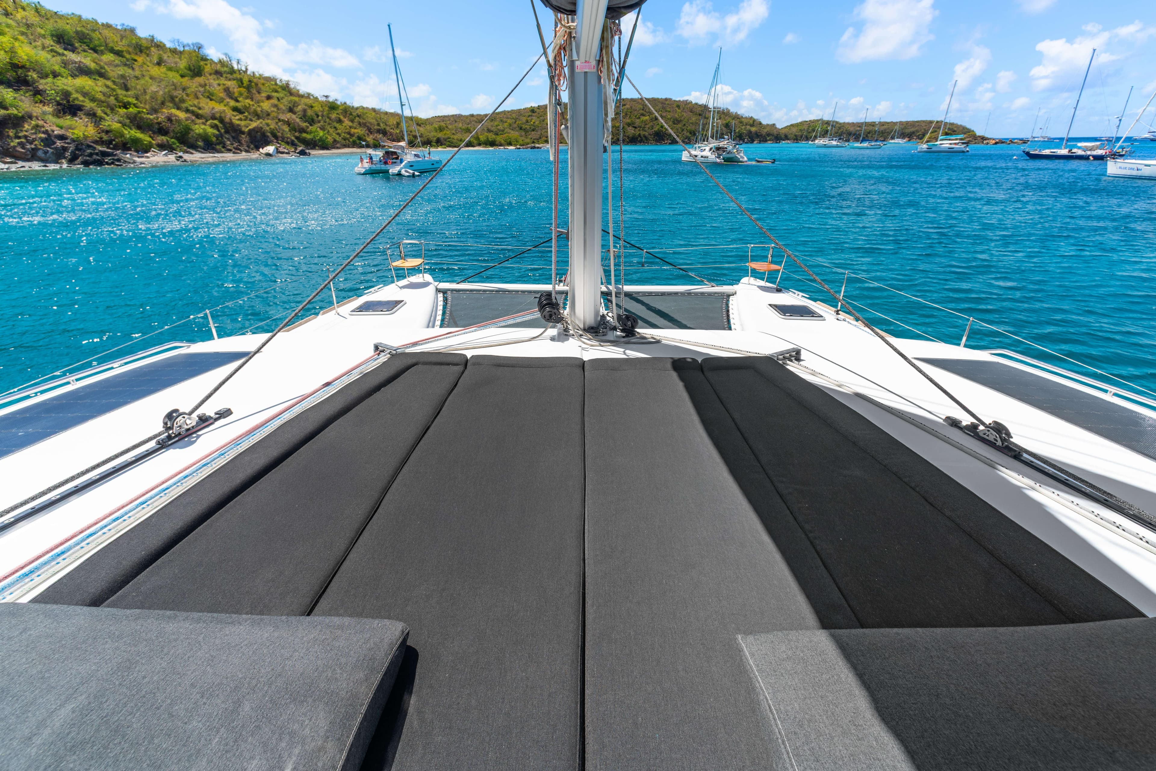 2017 Lagoon 450 F catamaran with sunbathing area, anchored in turquoise waters.