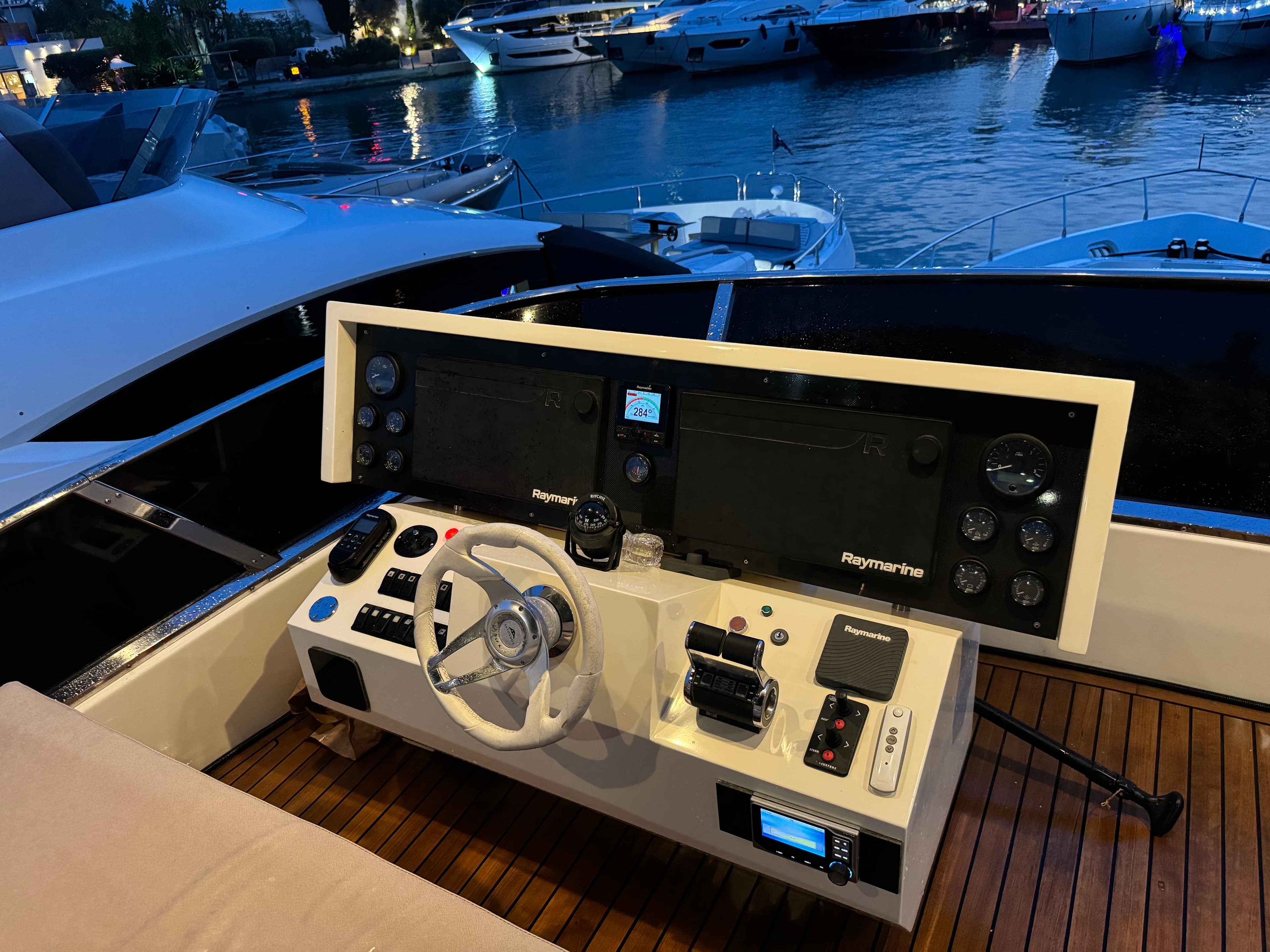 Cockpit of 2007 Astondoa A 76 GLX yacht with advanced navigation controls at marina.