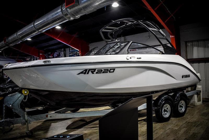 2023 Yamaha Boats AR220 on display in a showroom.