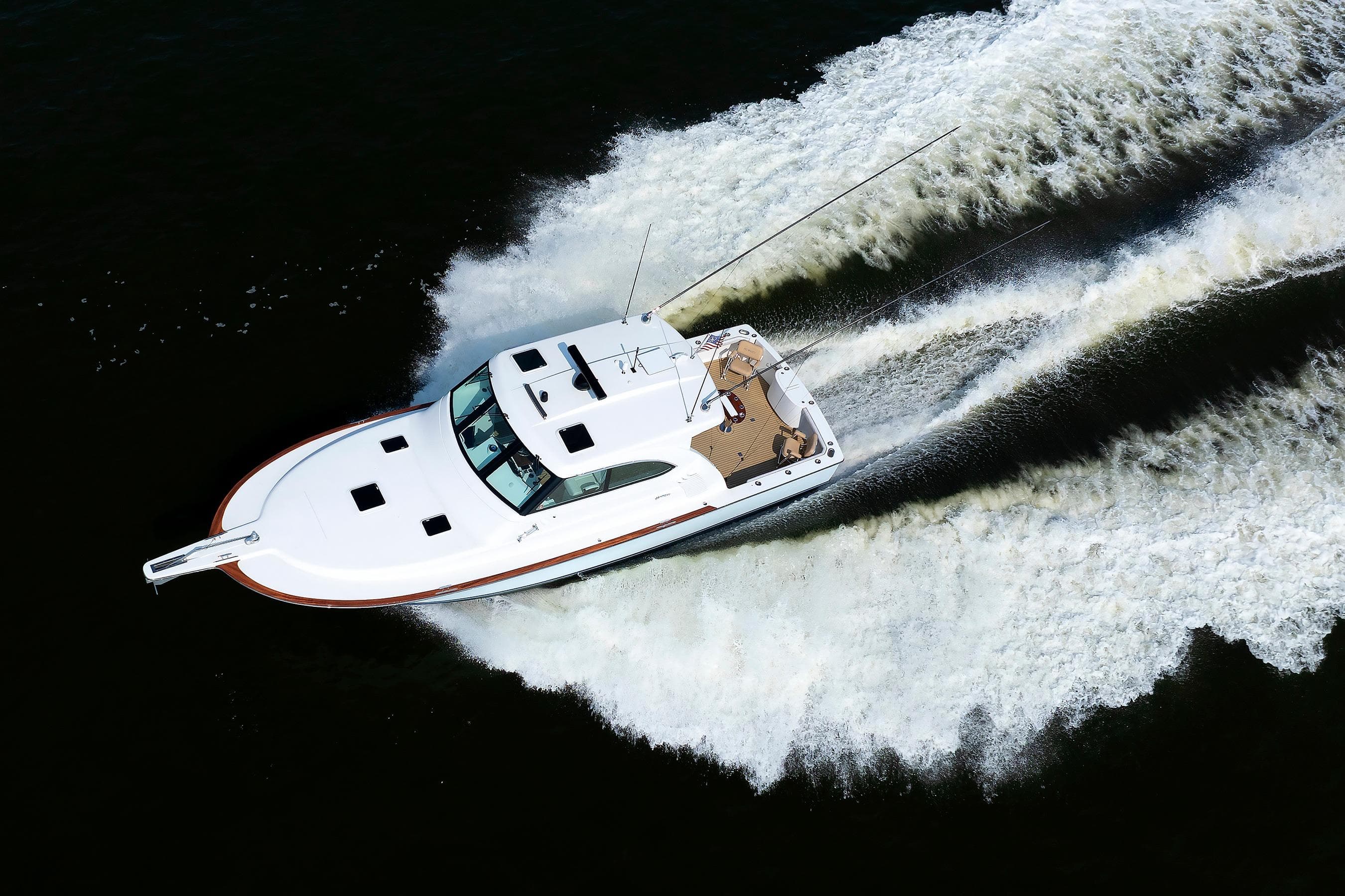 2023 Henriques 42 Express Hardtop cruising on water, aerial view.