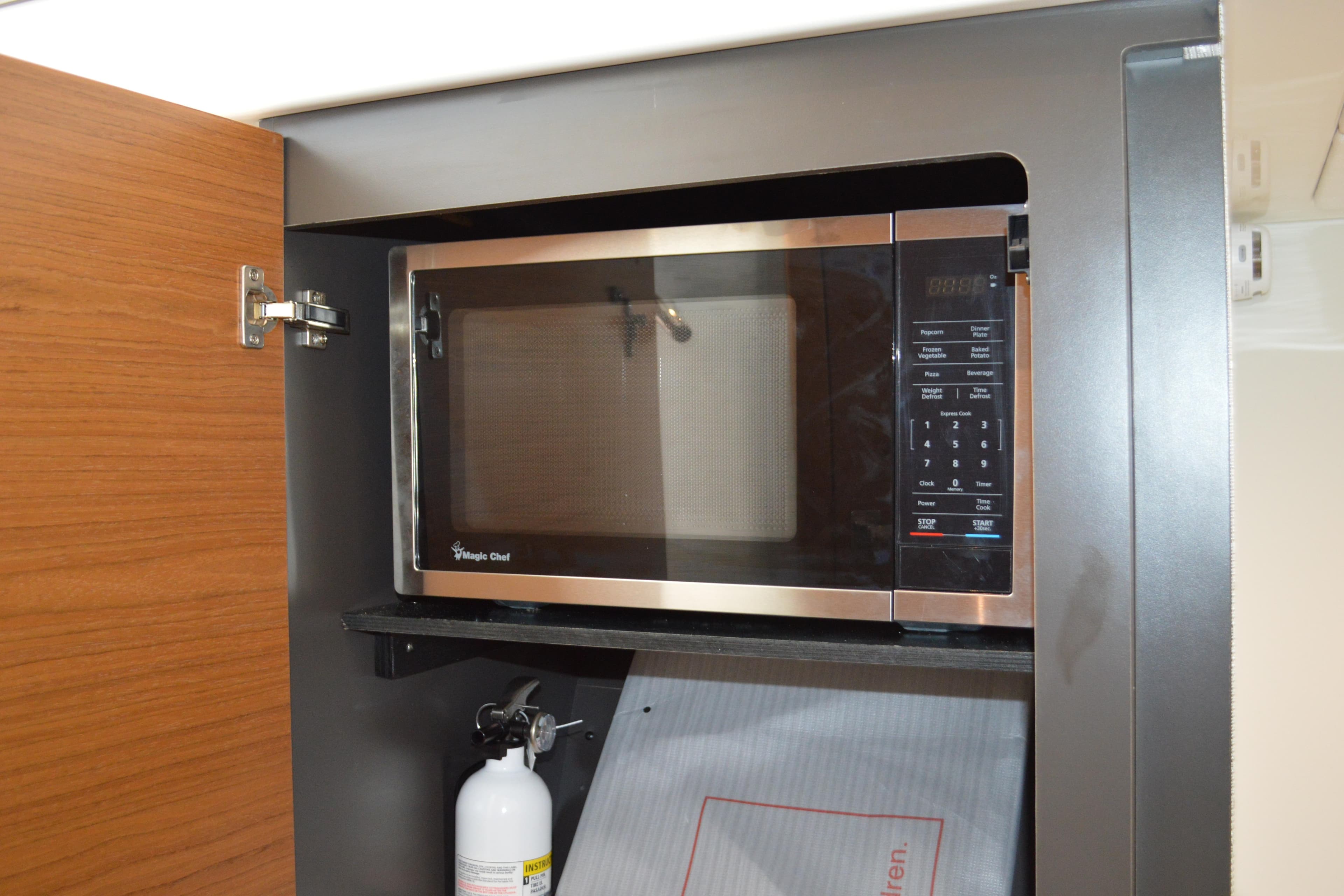 Microwave in 2024 Tiara Yachts 34 LS, with fire extinguisher below.