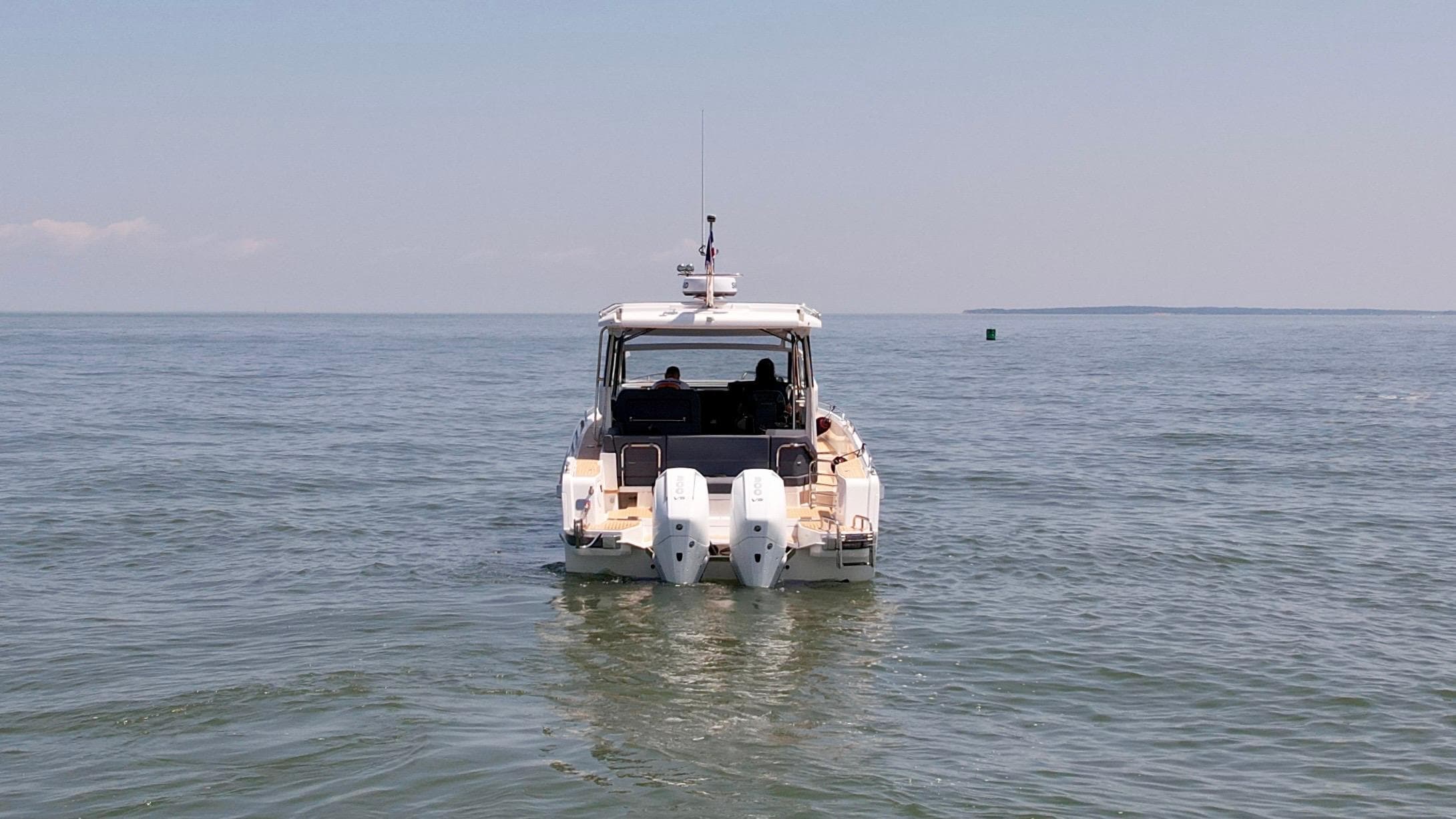 2024 Nimbus W11 boat cruising on open water, rear view.