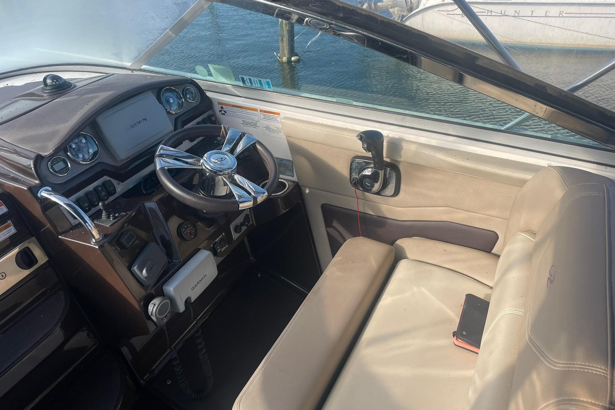 Cockpit of 2013 Regal 28 Express boat with steering wheel and navigation equipment.