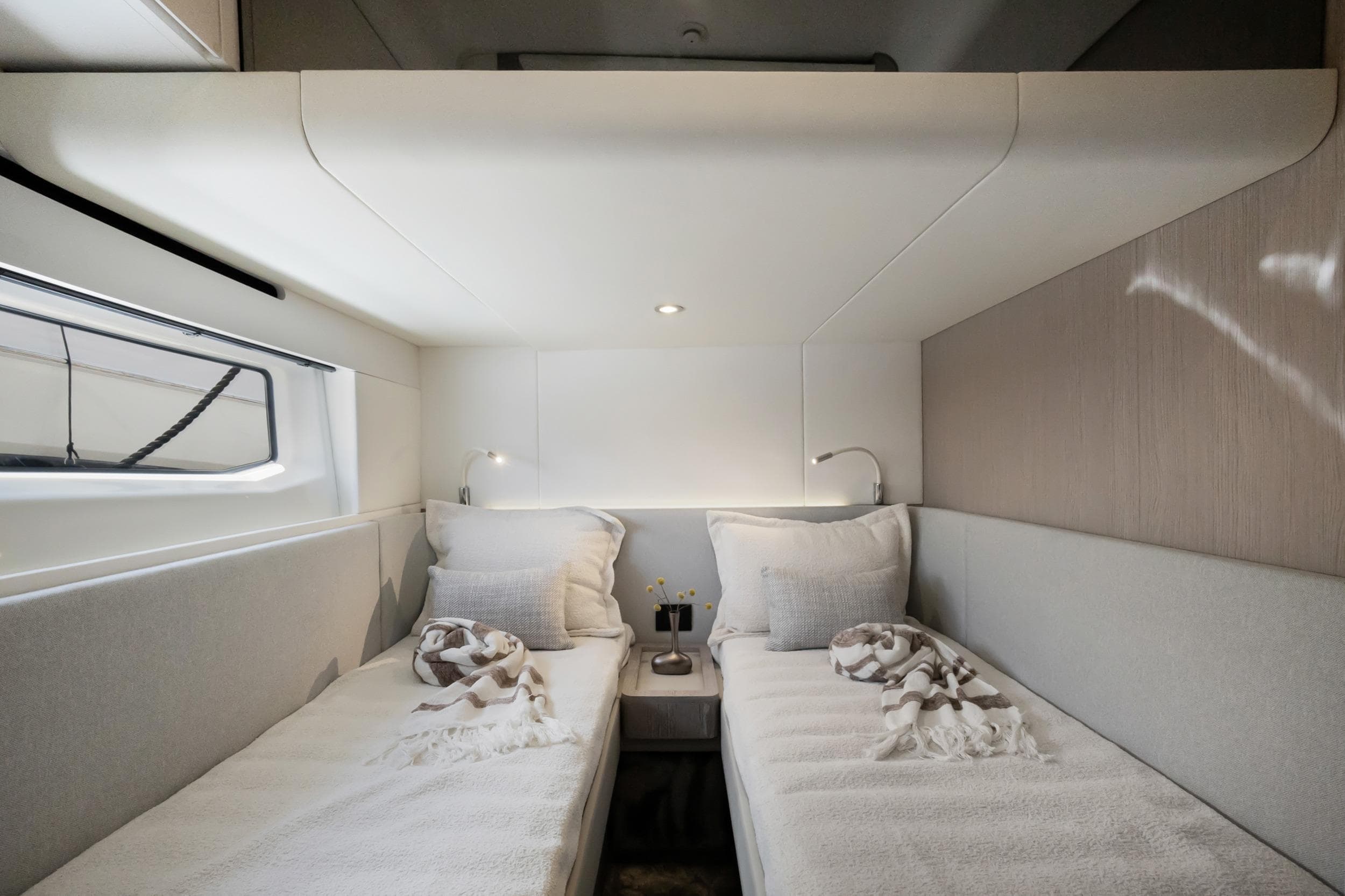 Luxurious twin cabin interior of 2024 Azimut Fly 53 yacht, featuring modern design and cozy bedding.