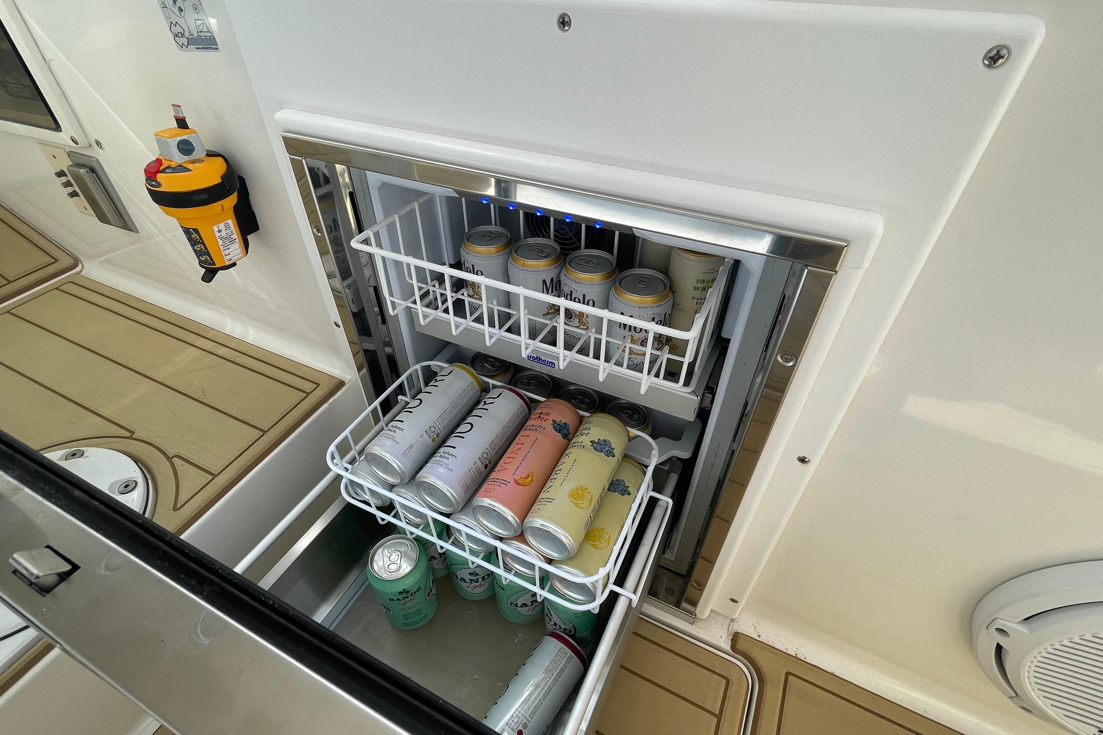 Built-in beverage cooler on 2009 Intrepid 430 Sport Yacht, stocked with assorted drinks.