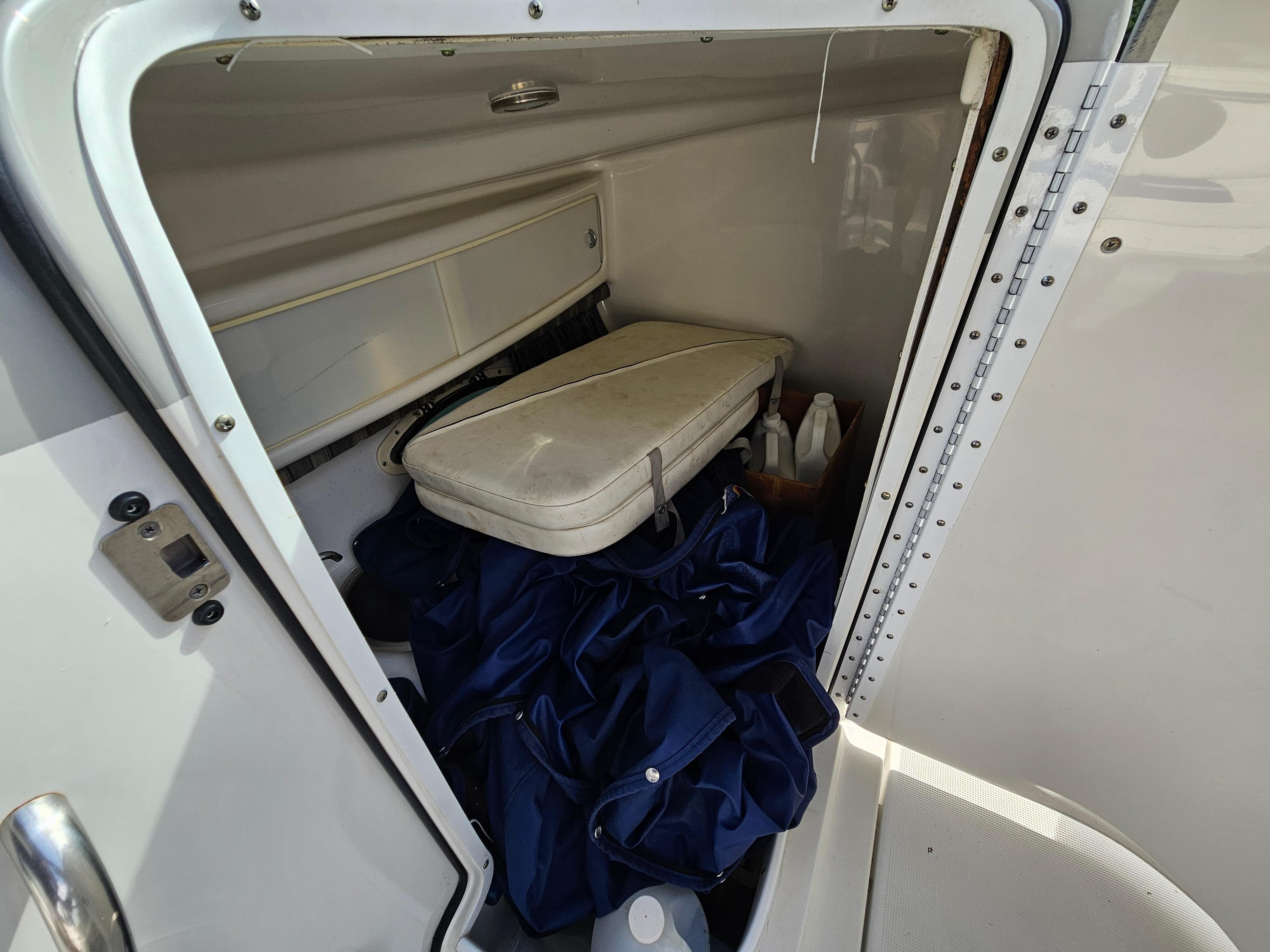Storage compartment of 2007 Formula 280 Bowrider boat with cushions and supplies.