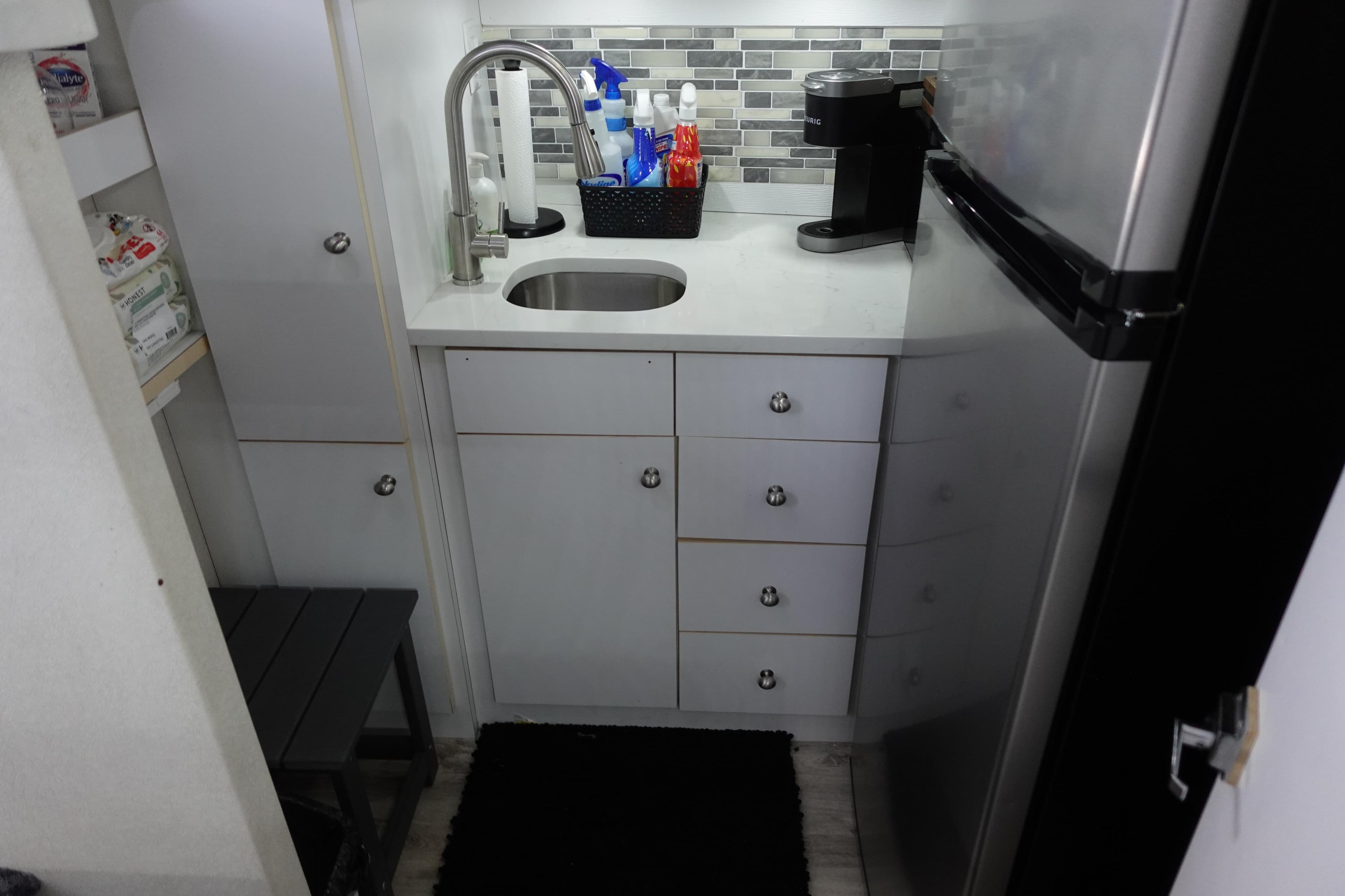 Compact kitchen area in a 1993 Silverton 31 Convertible boat with modern amenities.