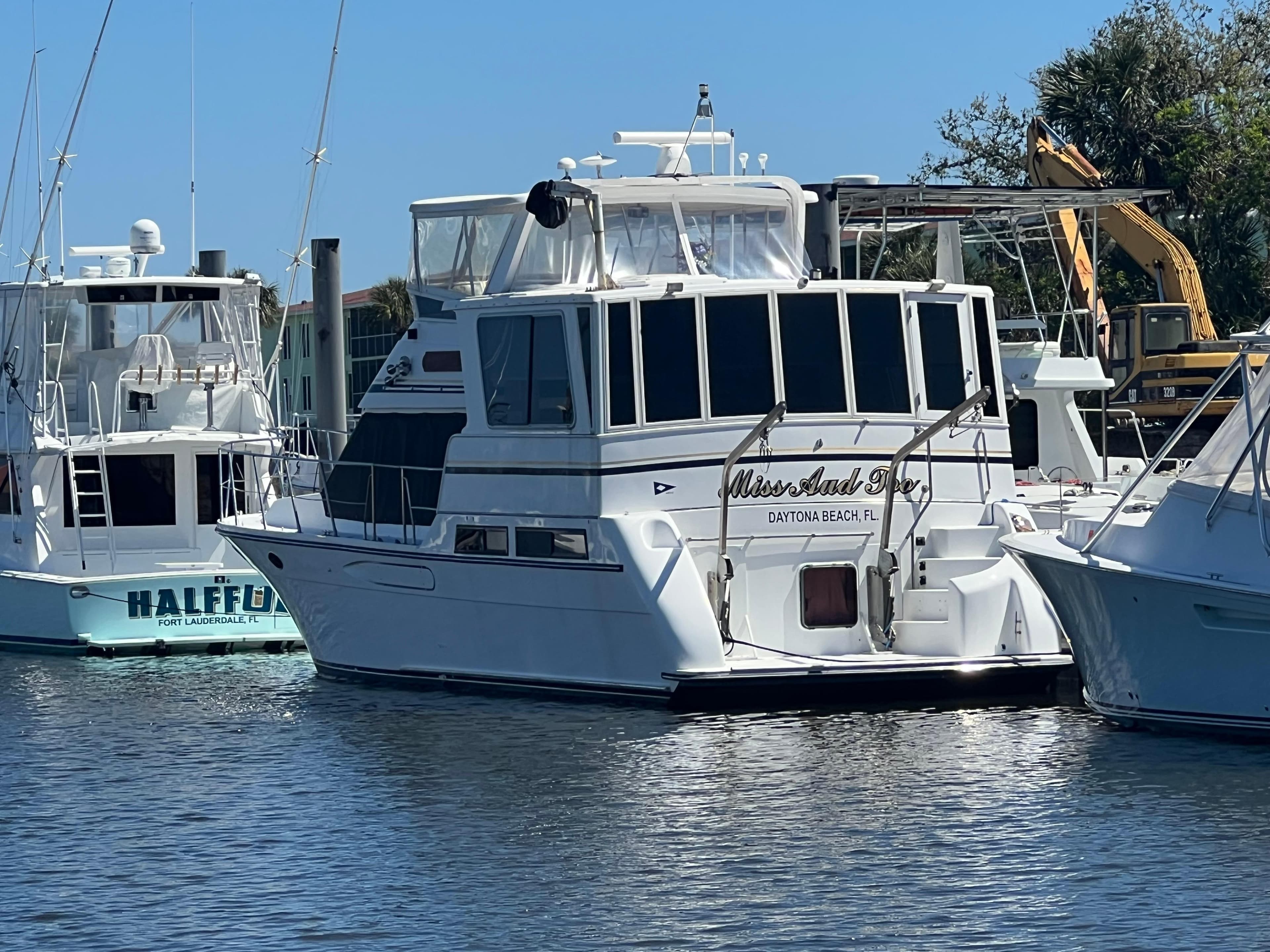 1998 Hyatt 51 Aft Cabin Motor Yacht docked at marina, sunny day.