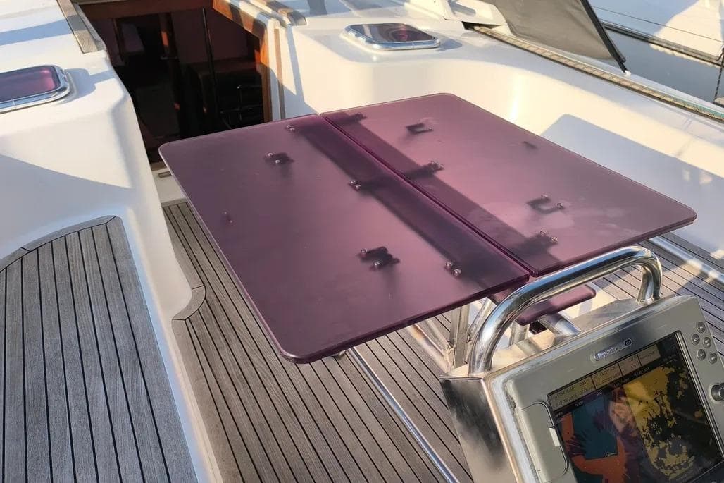 Cockpit of 2007 Hanse 470e yacht with purple table and navigation equipment.