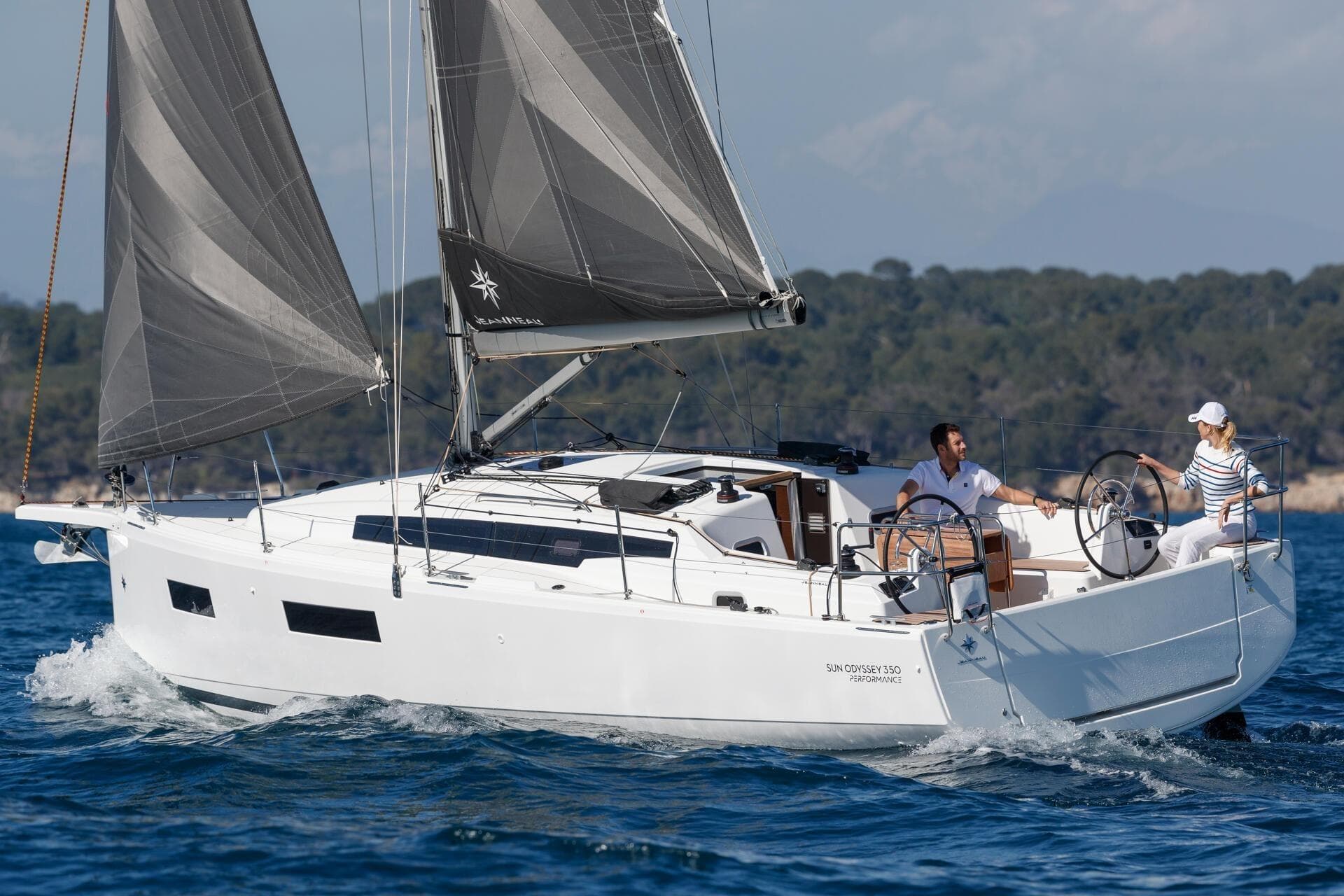2026 Jeanneau Sun Odyssey 350 sailing on open water with two people onboard.