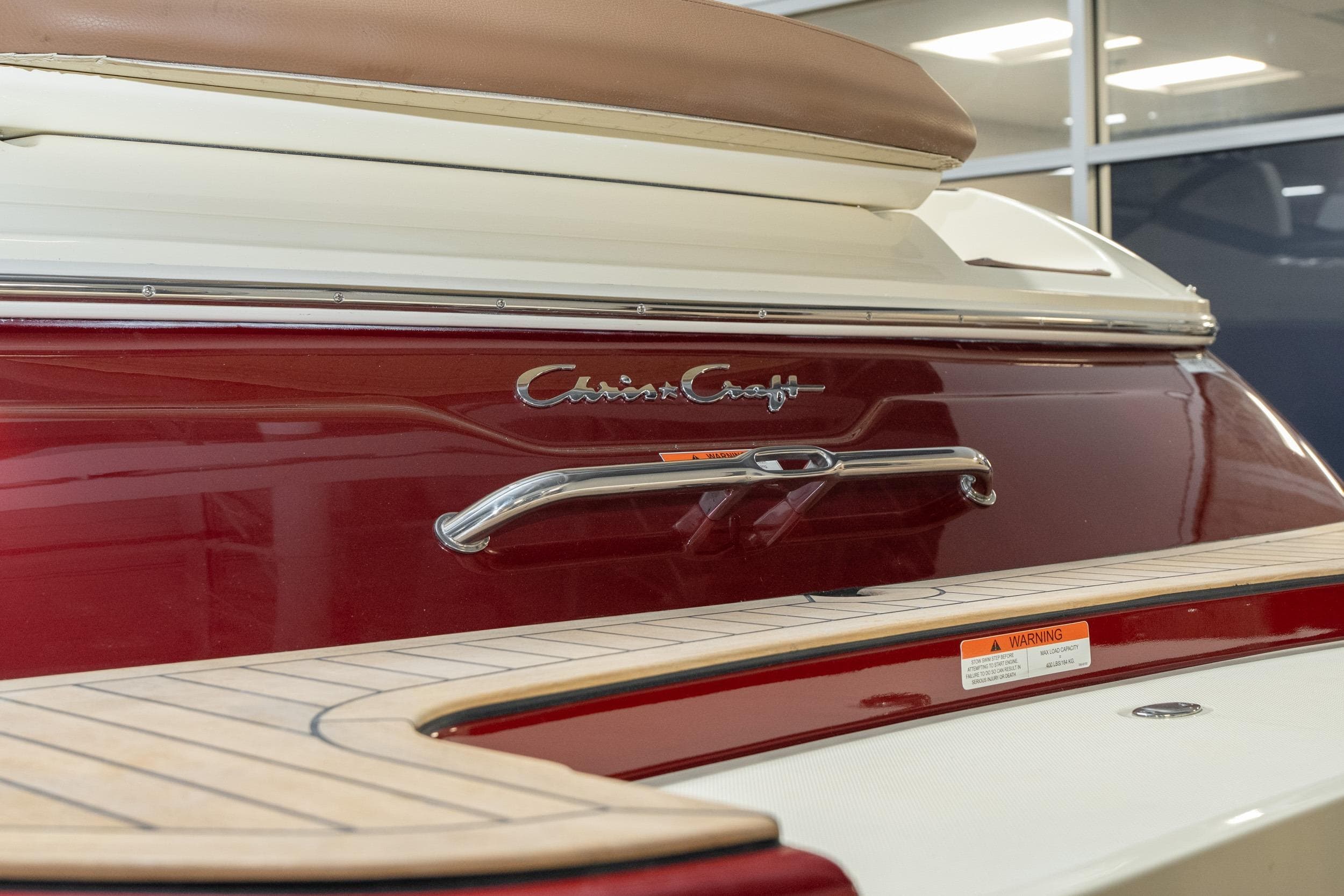 2026 Chris-Craft Sportster 28 boat, featuring elegant red and white design with chrome accents.