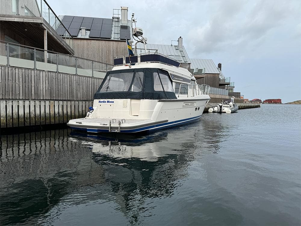 Storebro 435 Commander 2014 yacht docked by modern waterfront buildings.