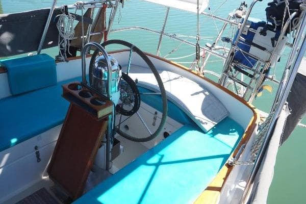 1982 Bristol 35.5 sailboat cockpit with blue cushions and steering wheel.