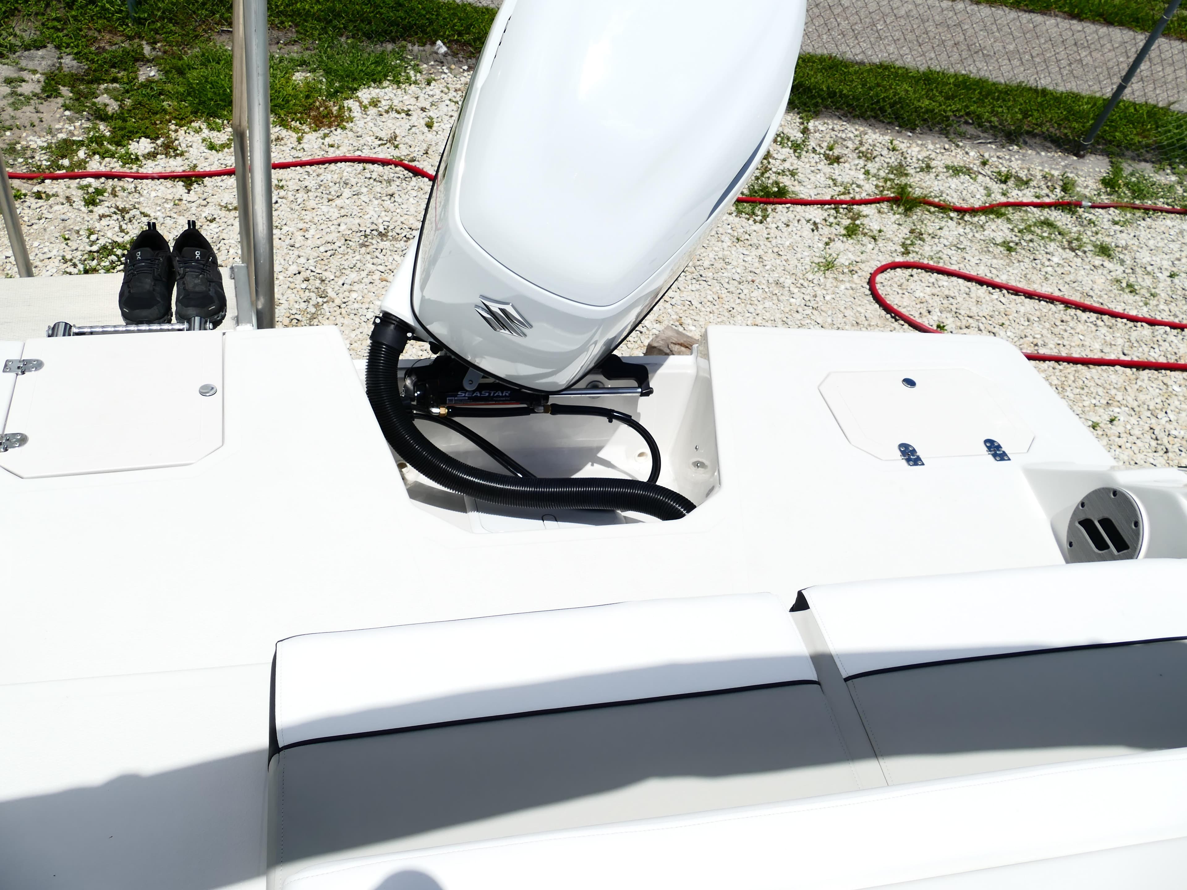 2026 Starcraft SVX 231 OB DH boat with Suzuki outboard motor, white deck, and storage compartments.