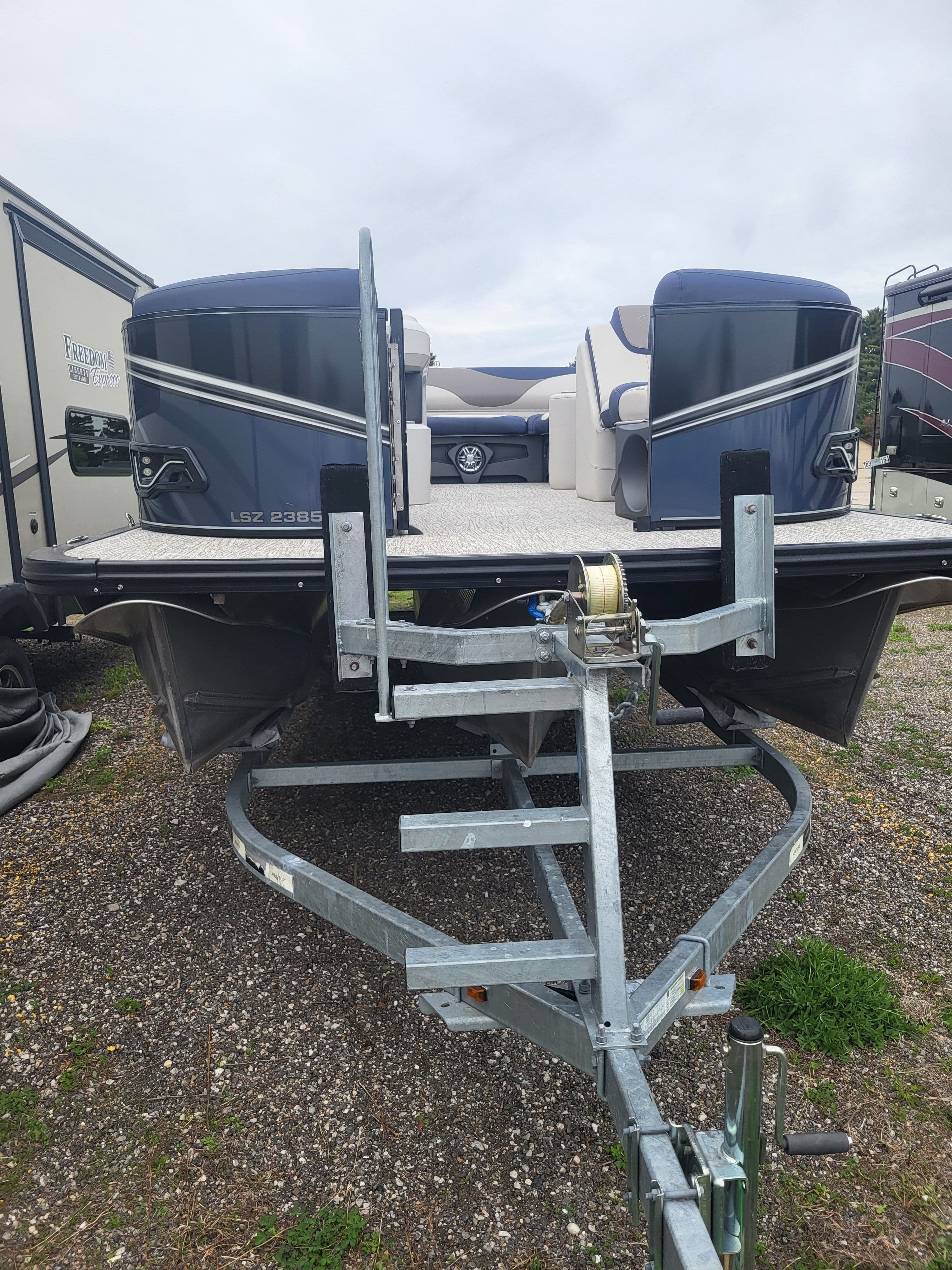 2023 Avalon 2385 LSZ pontoon boat on trailer, side view.