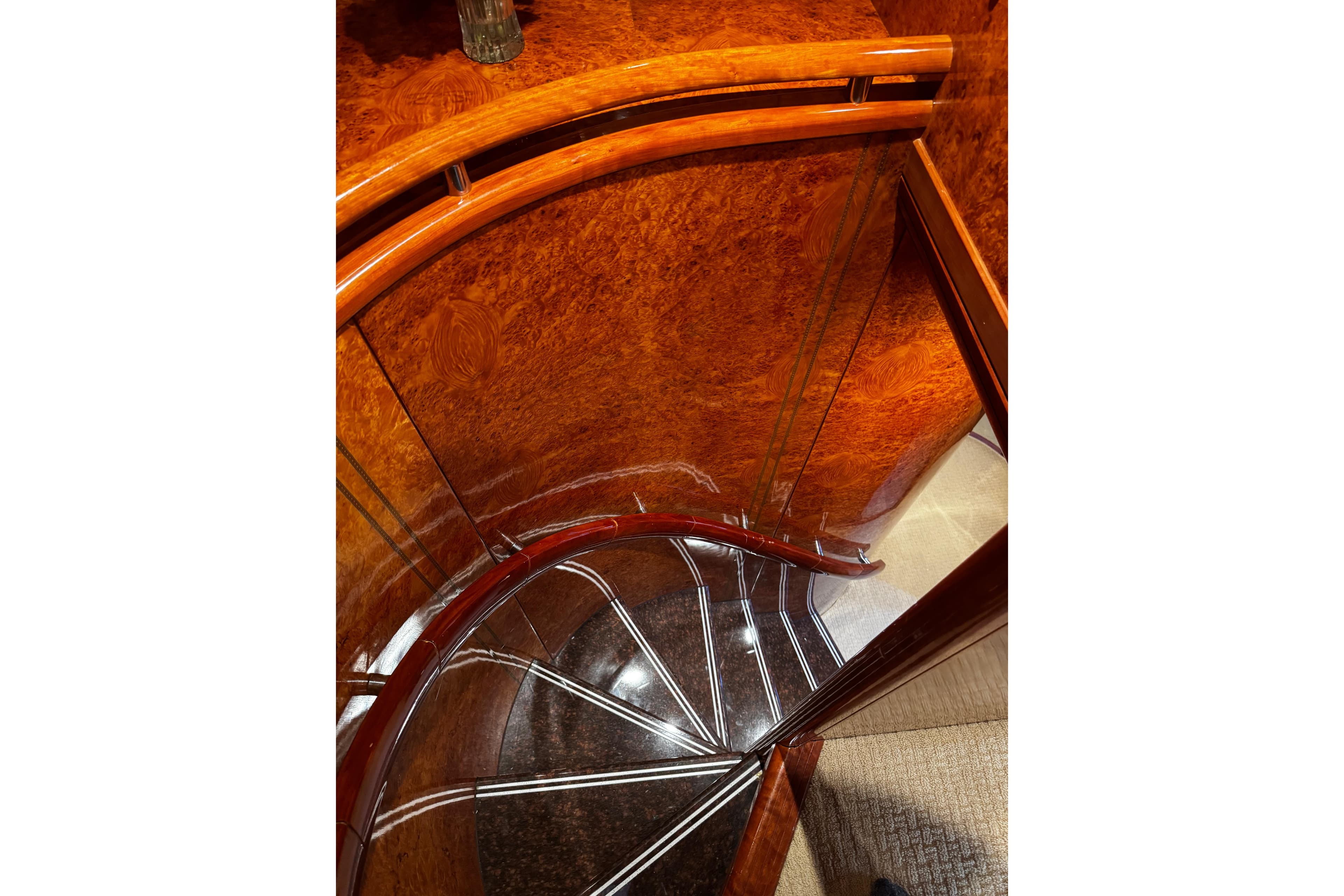 Luxurious wooden staircase on 1996 Hershine Benship 87 yacht interior.