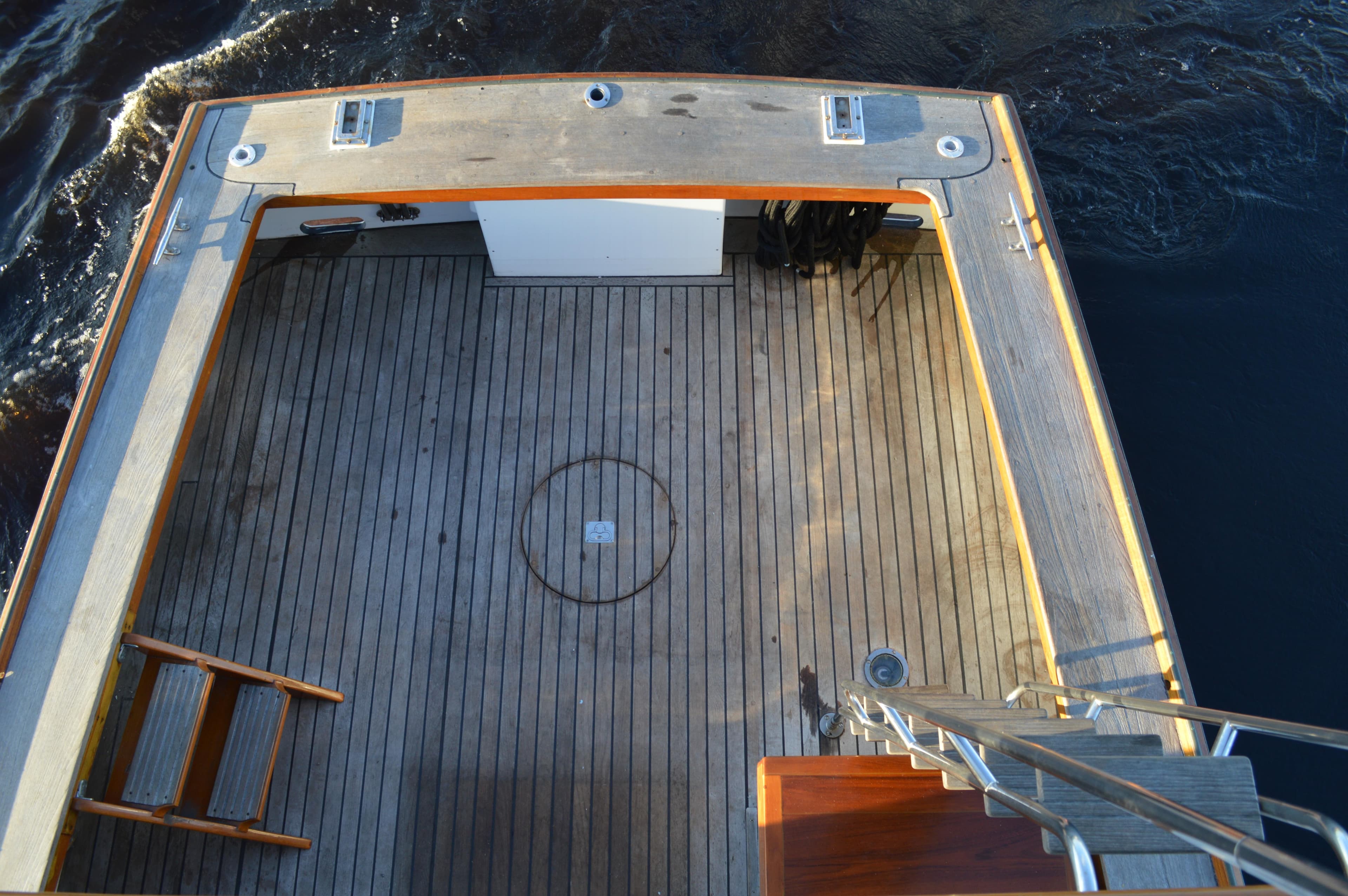 Stanley Downeast Lobster Boat deck, 1990 model, featuring wooden flooring and ocean backdrop.