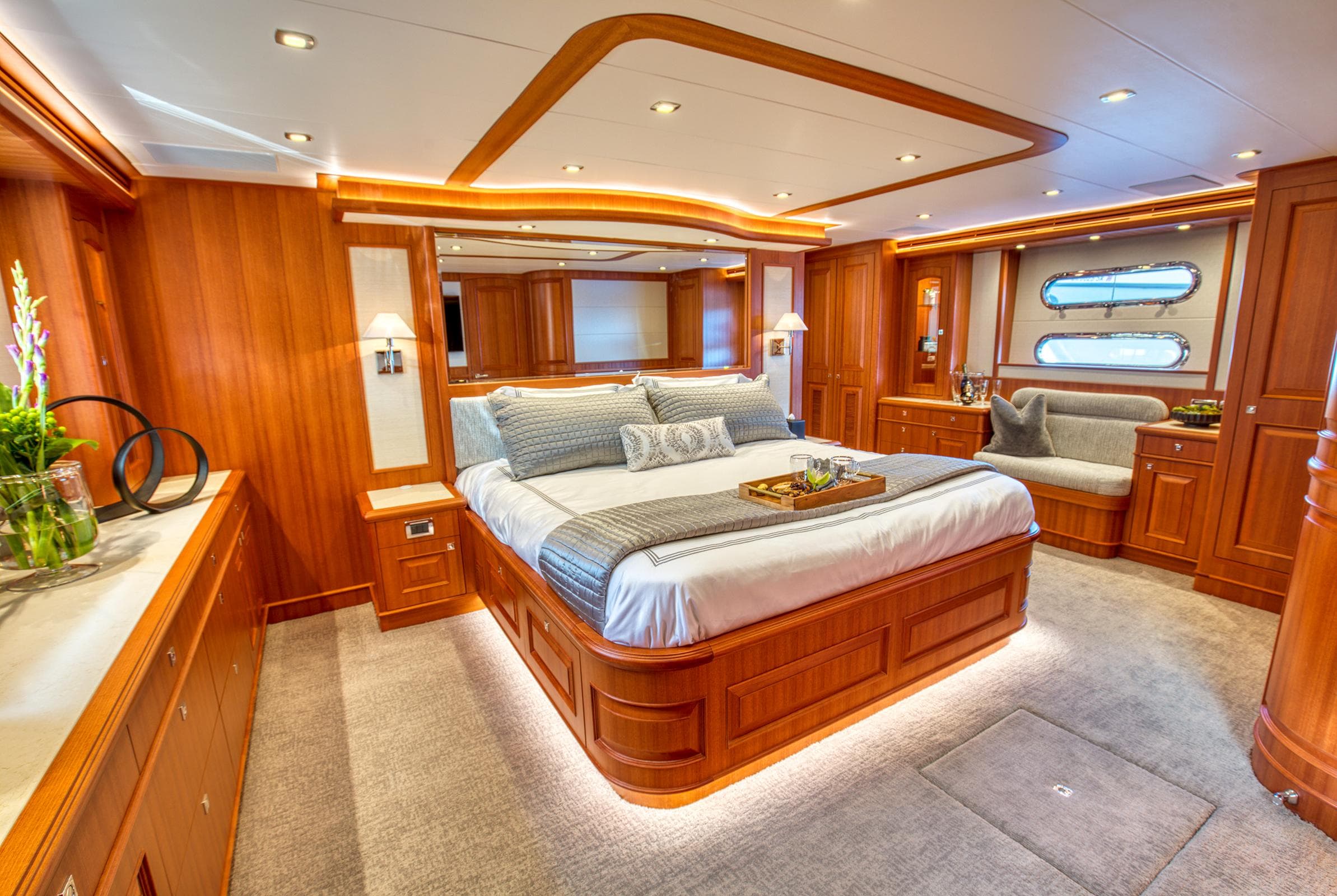 Luxurious bedroom interior of 2025 Hampton 750 Endurance LRC yacht with elegant wood finishes.