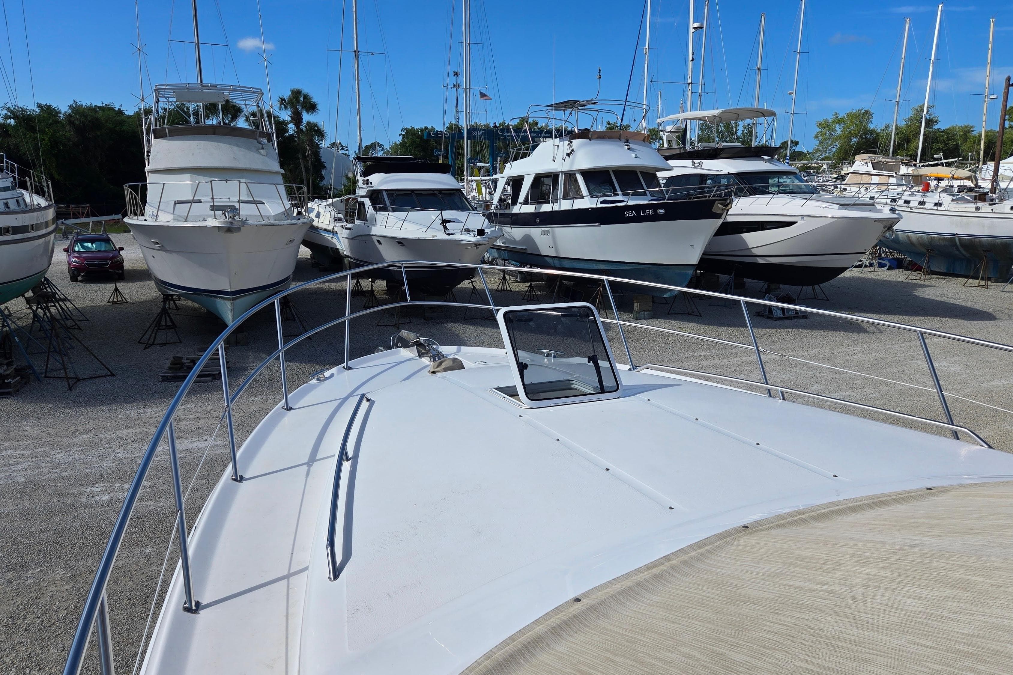 2001 Sea Ray 400 Sedan Bridge yacht in a marina with other boats.