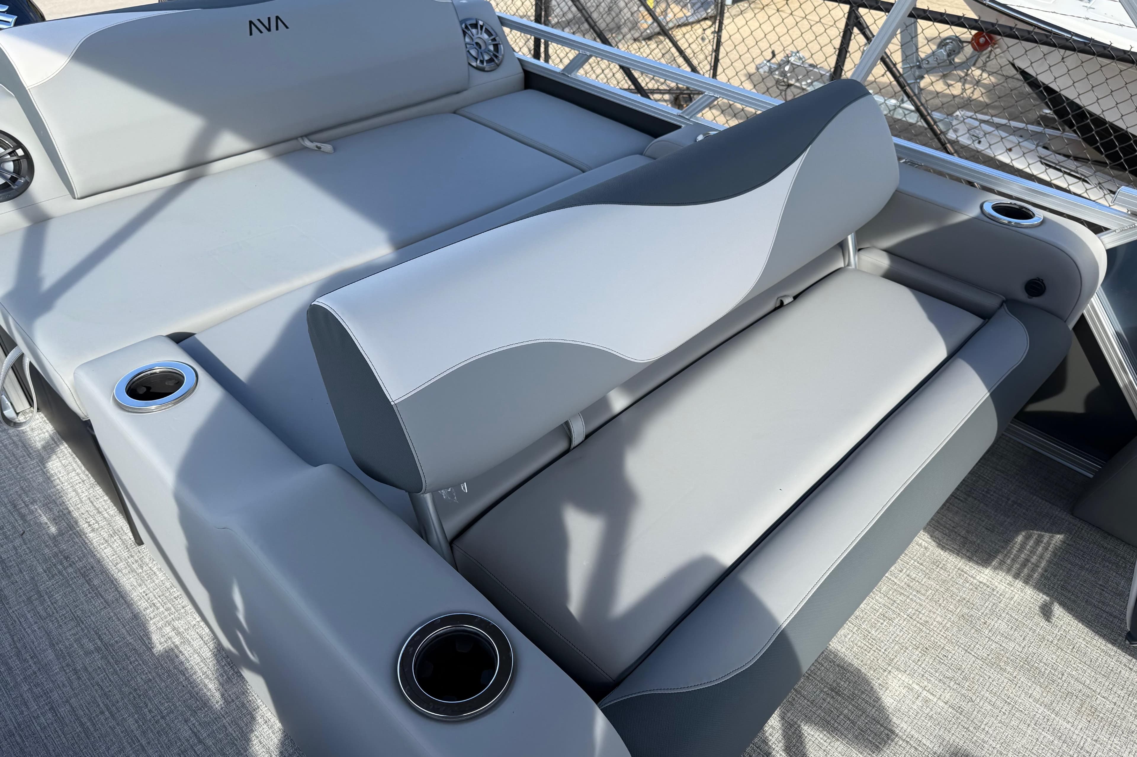 2026 Avalon LSZ Versatile Rear Lounger with gray seating and cup holders on a boat deck.