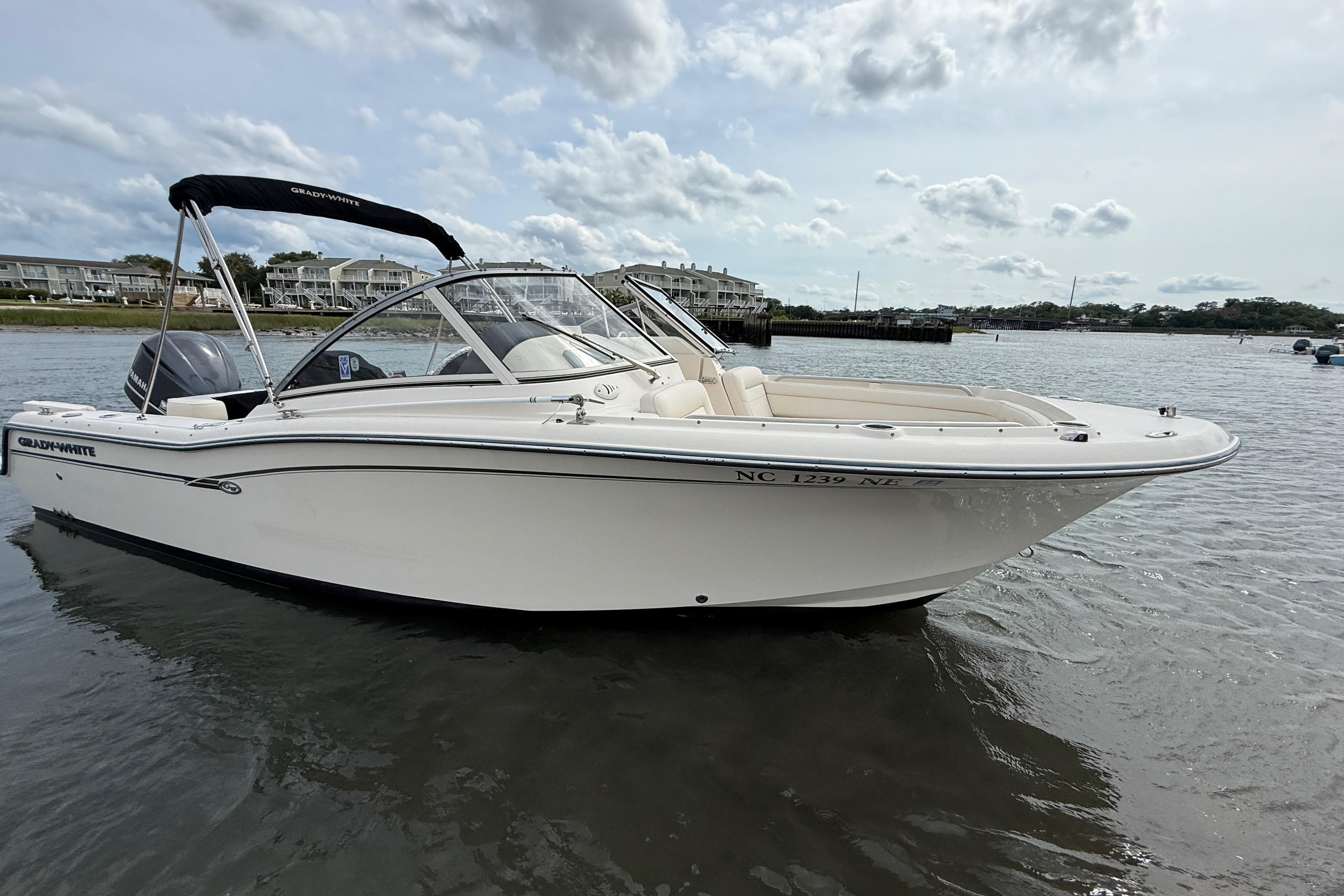 2017 Grady-White Freedom 235 boat on calm water with scenic background.