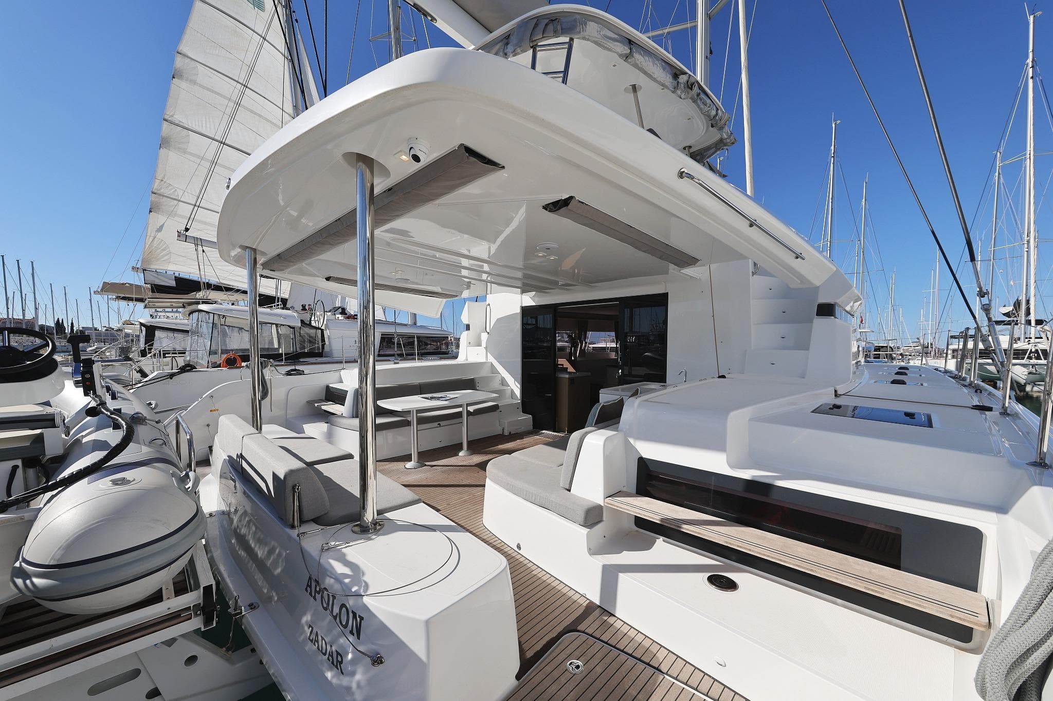 2024 Lagoon 51 yacht with spacious deck and modern design in marina setting.