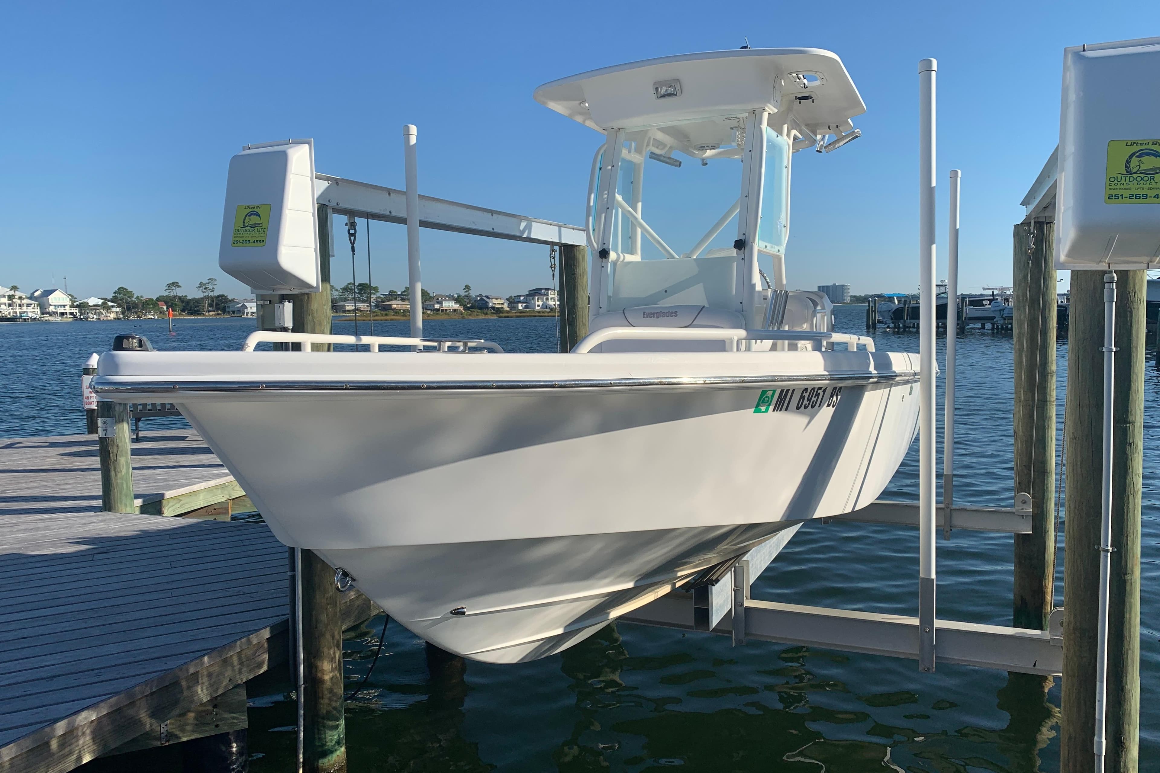 2008 Everglades 223 Center Console boat on lift at marina dock.