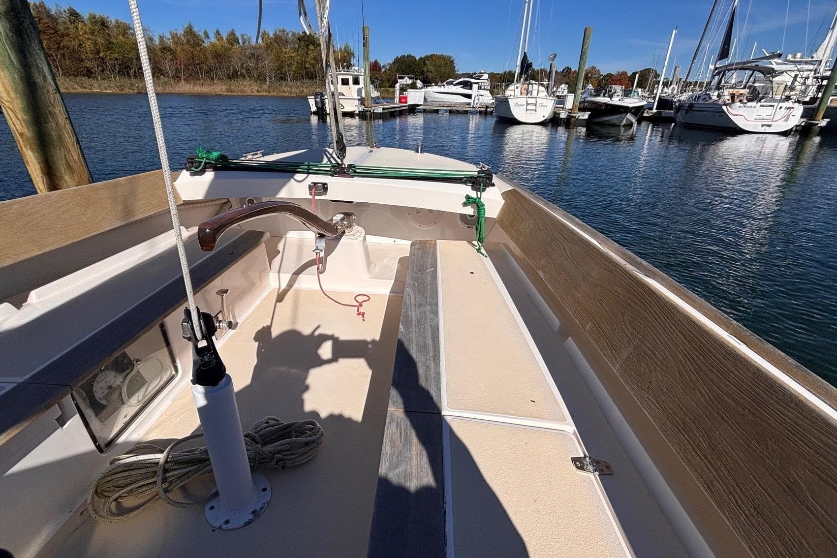 2016 Alerion Express 28 sailboat docked in a marina, showcasing its cockpit and deck.
