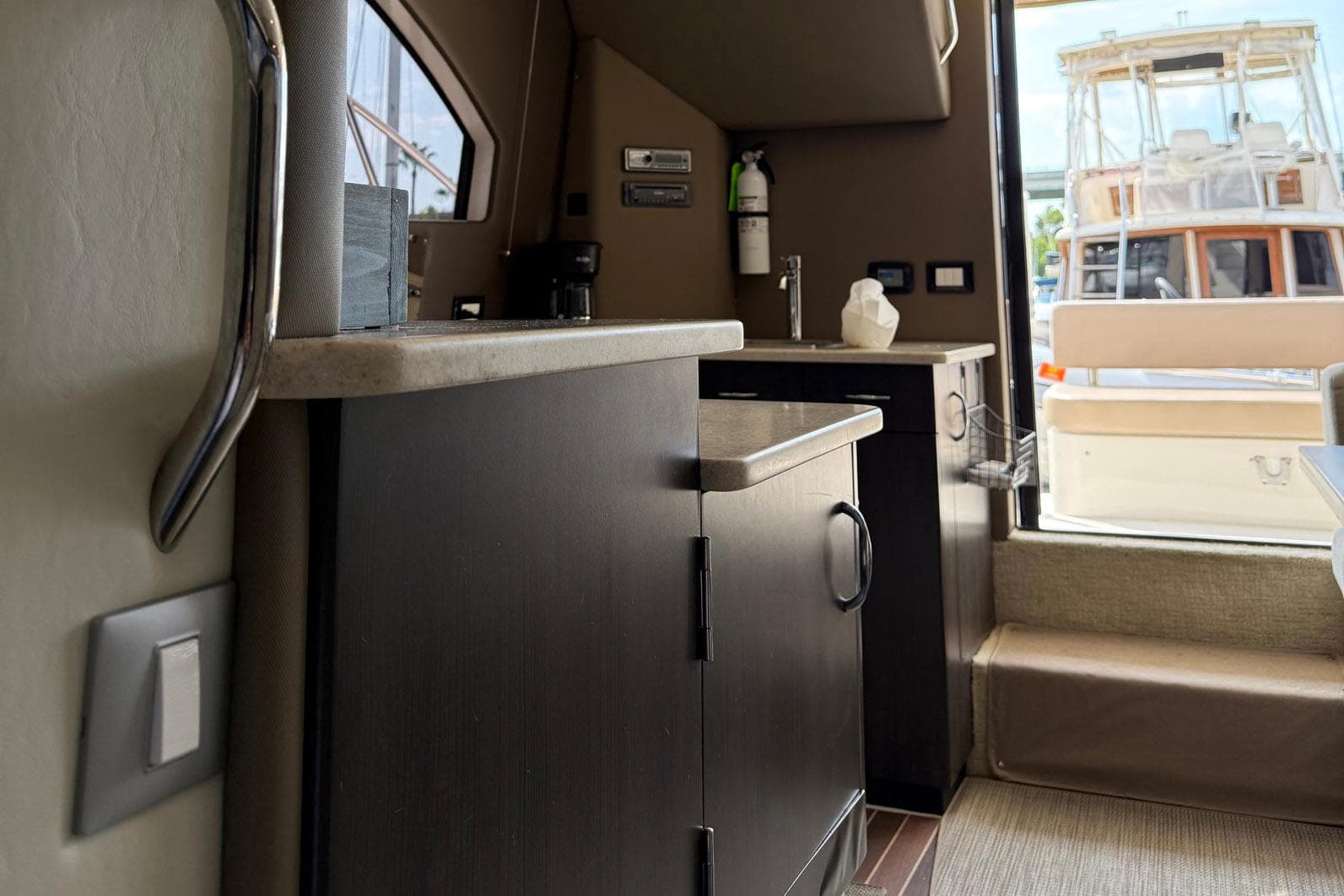 Interior of a 2013 Carver C34 yacht, featuring a compact kitchen area.