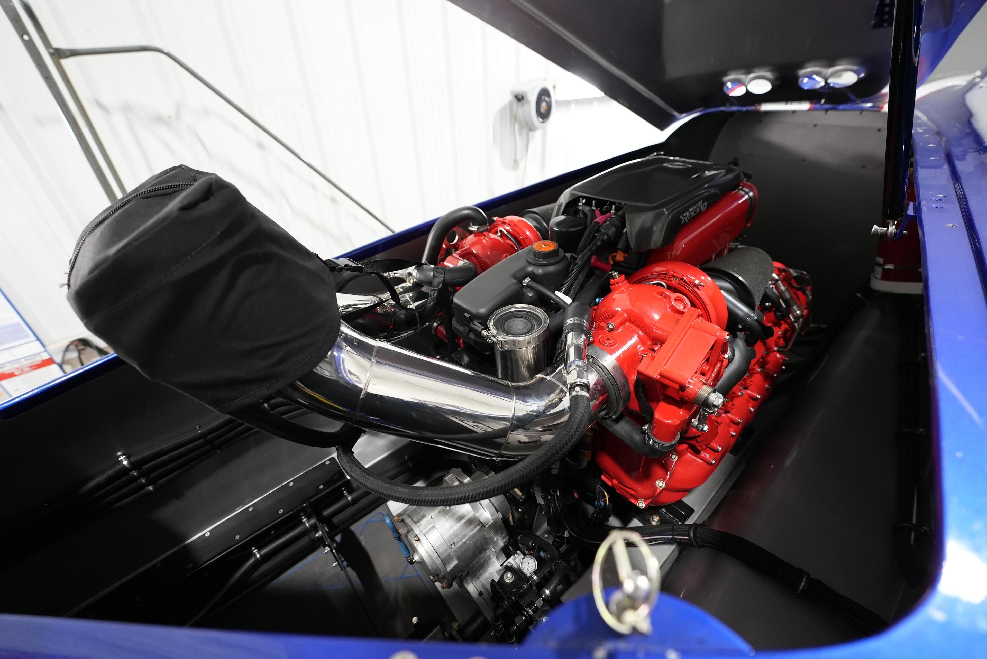Engine of 2007 Mystic Powerboats 50', featuring red components and chrome detailing.