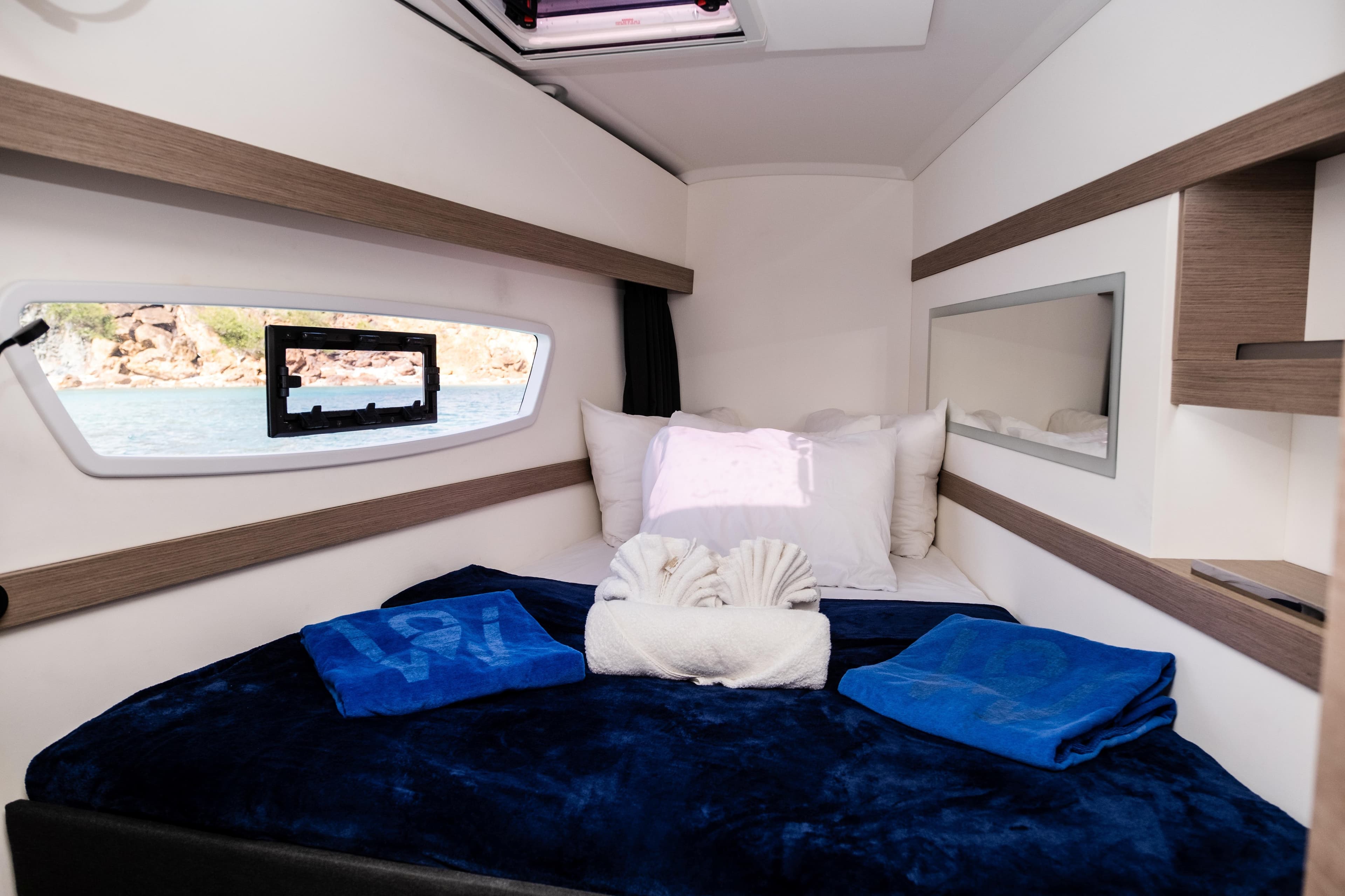 Luxurious cabin interior of 2023 Fountaine Pajot Isla 40 catamaran with cozy bedding.