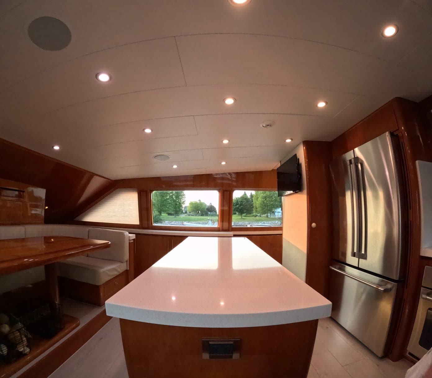 Luxurious kitchen interior of 2007 Hargrave 93' yacht with modern appliances and seating area.