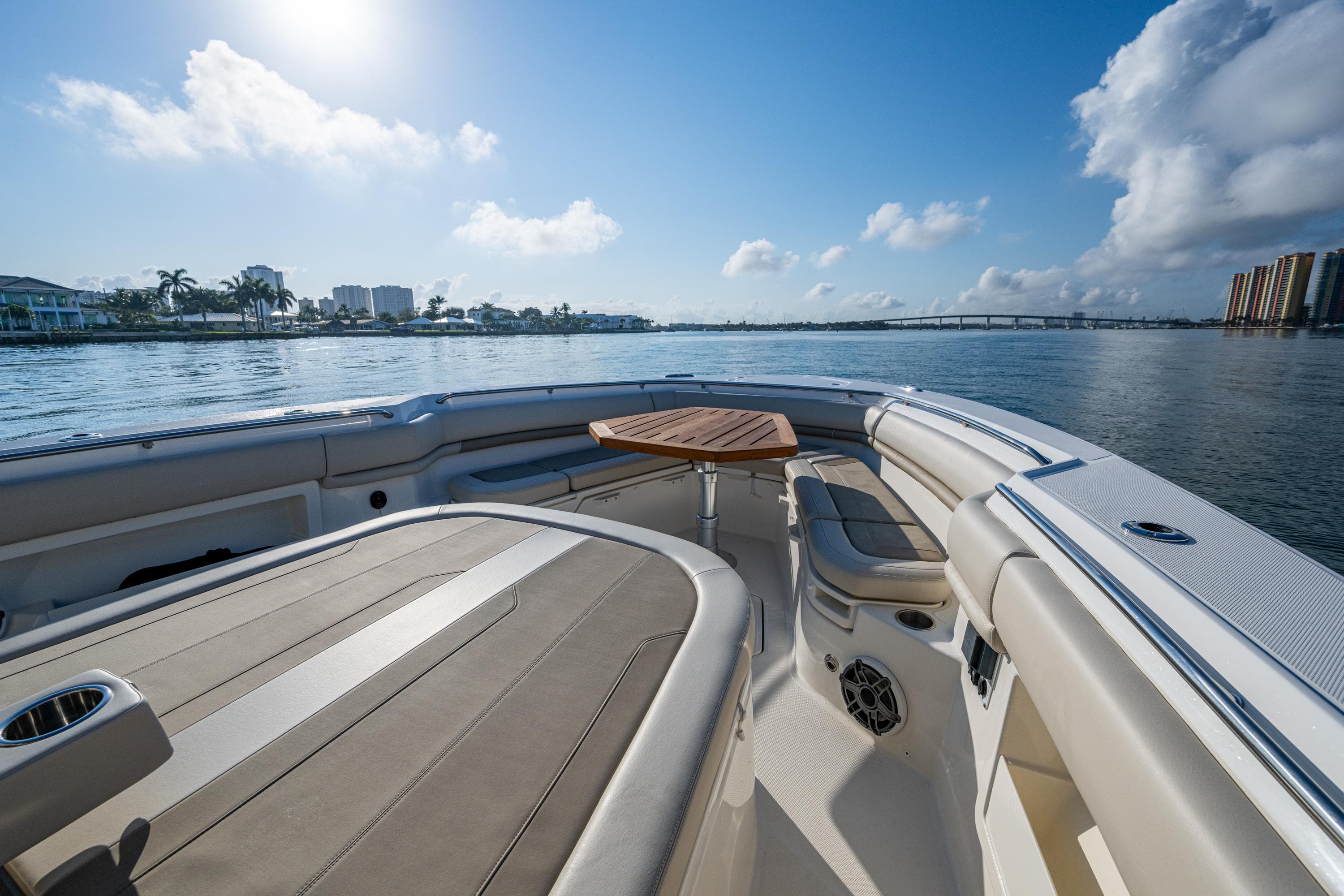 2024 Boston Whaler 380 Outrage boat interior with seating and table, on a sunny day.