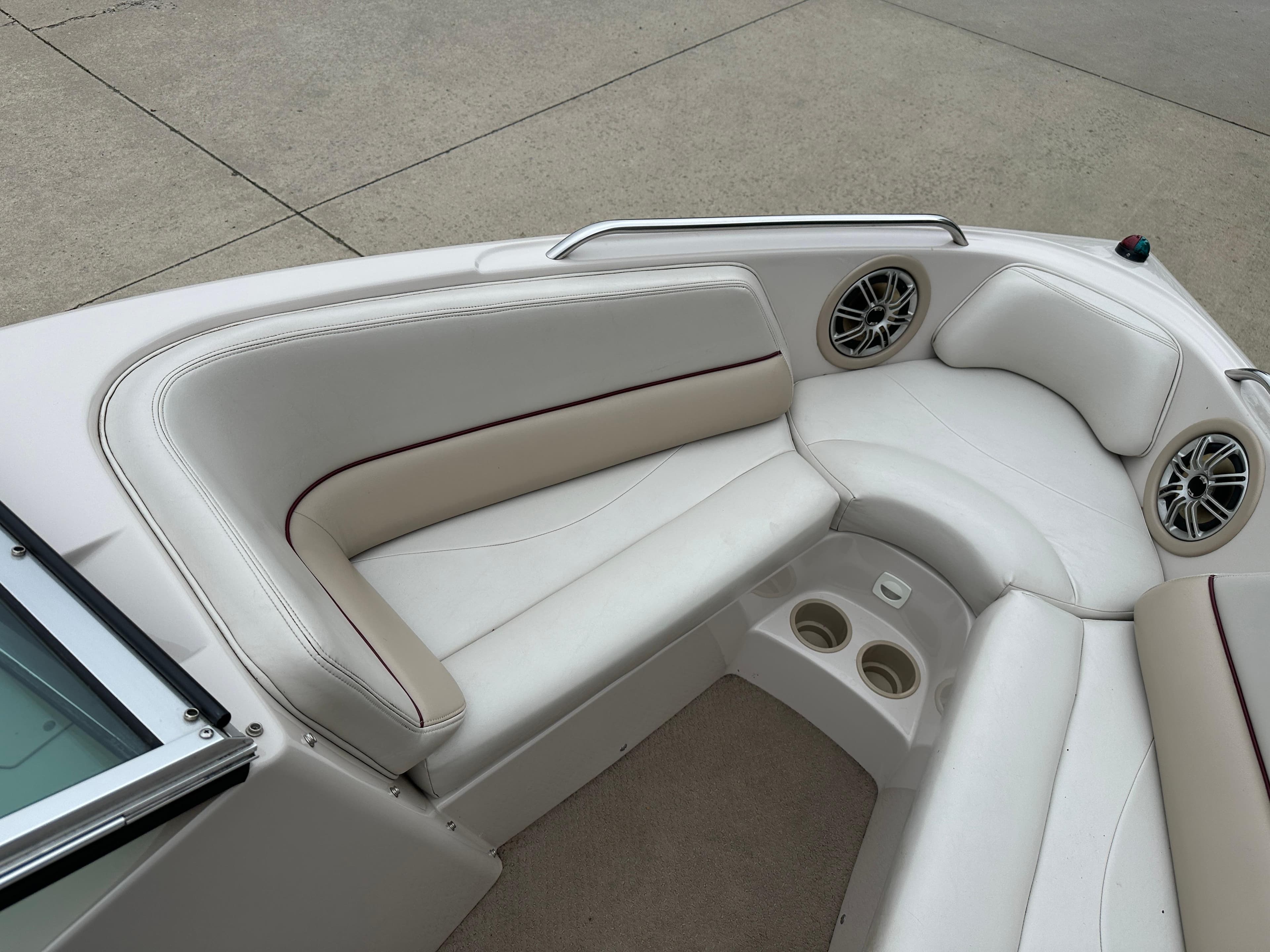 1999 MasterCraft MariStar 210 VRS boat interior with white seating and cup holders.