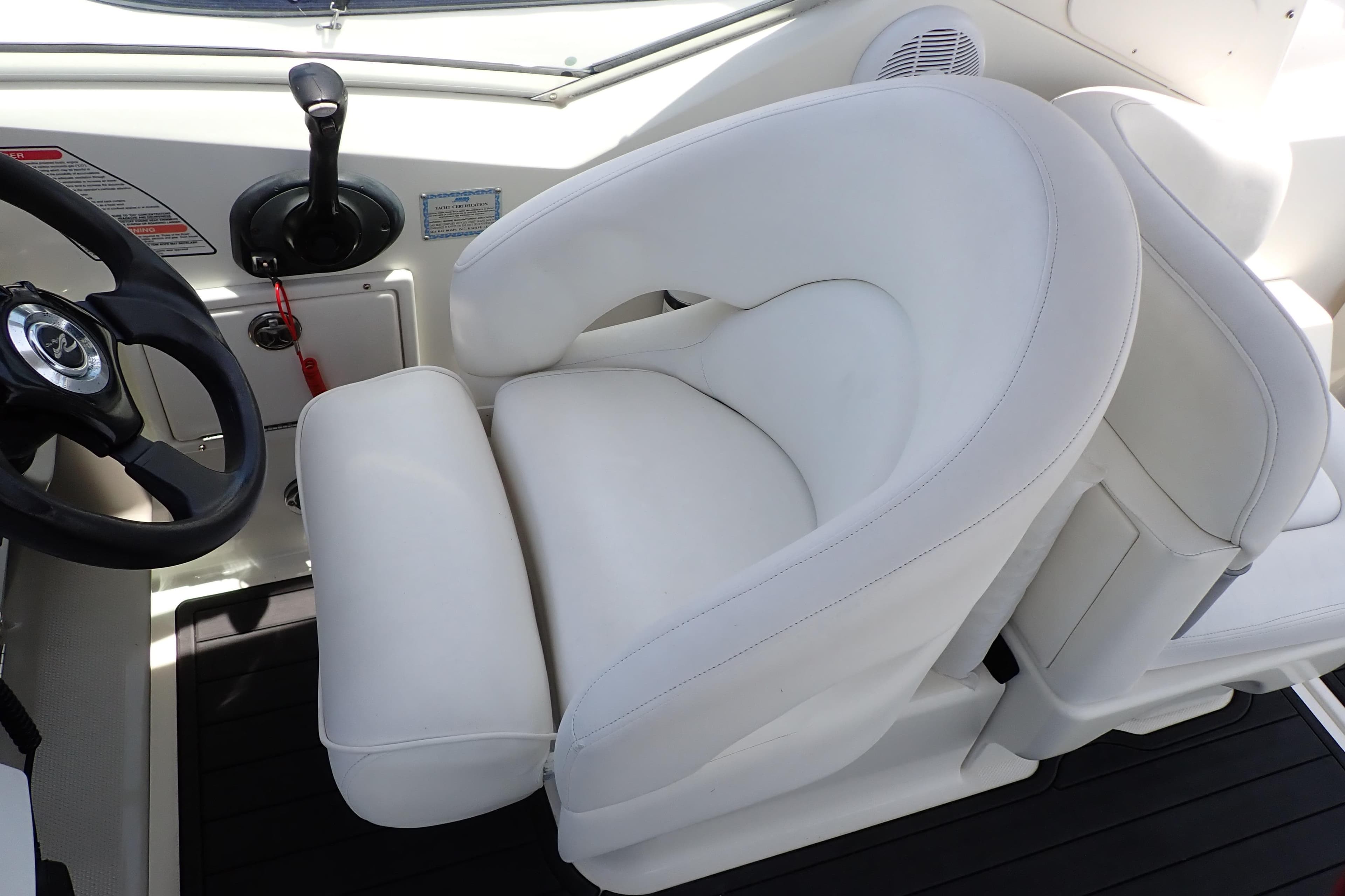Captain's seat and steering wheel of 2005 Sea Ray Sundancer 260 boat.