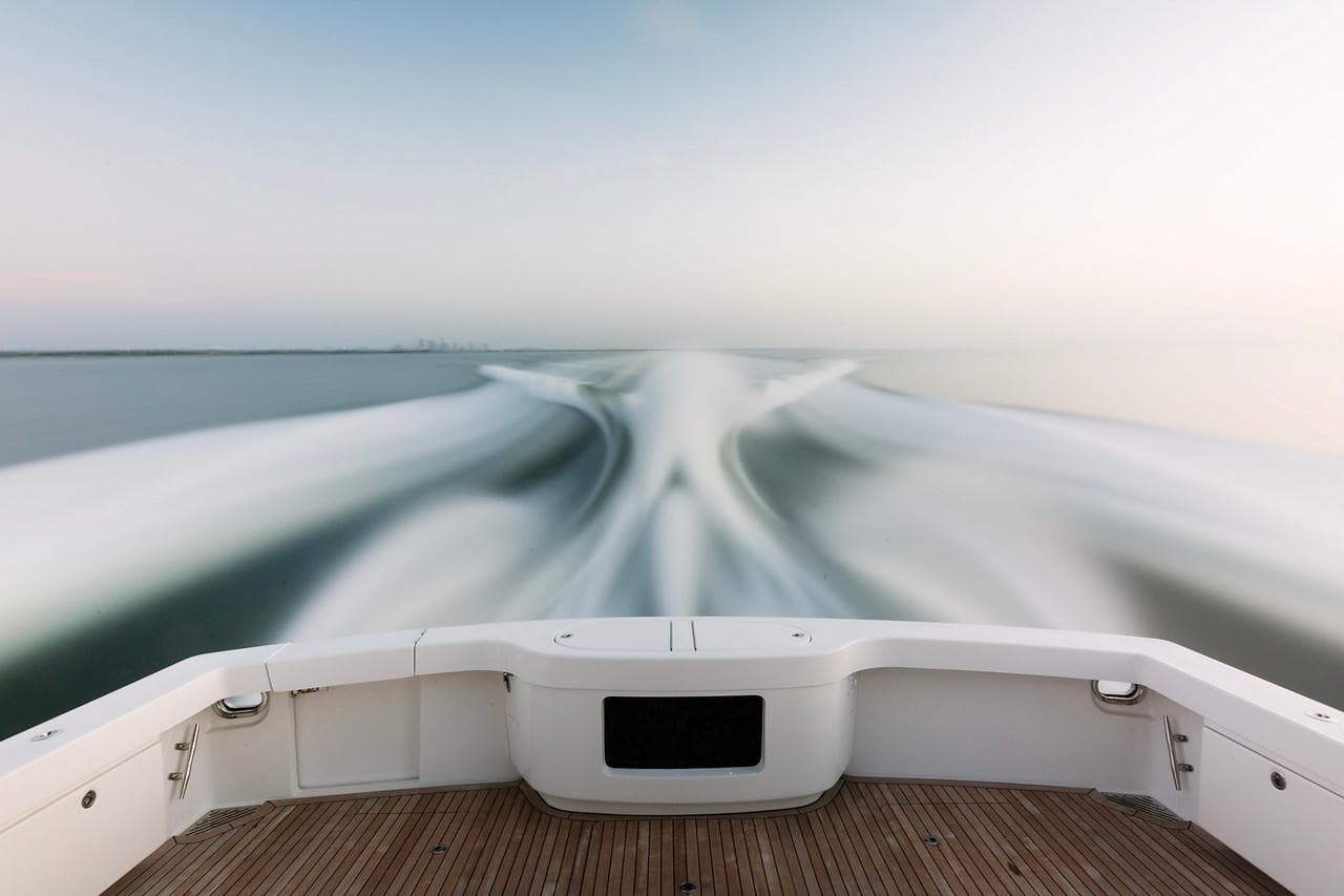 Manufacturer Provided Image: 2026 Bertram 61 Convertible yacht cruising, leaving a dynamic wake on calm waters.
