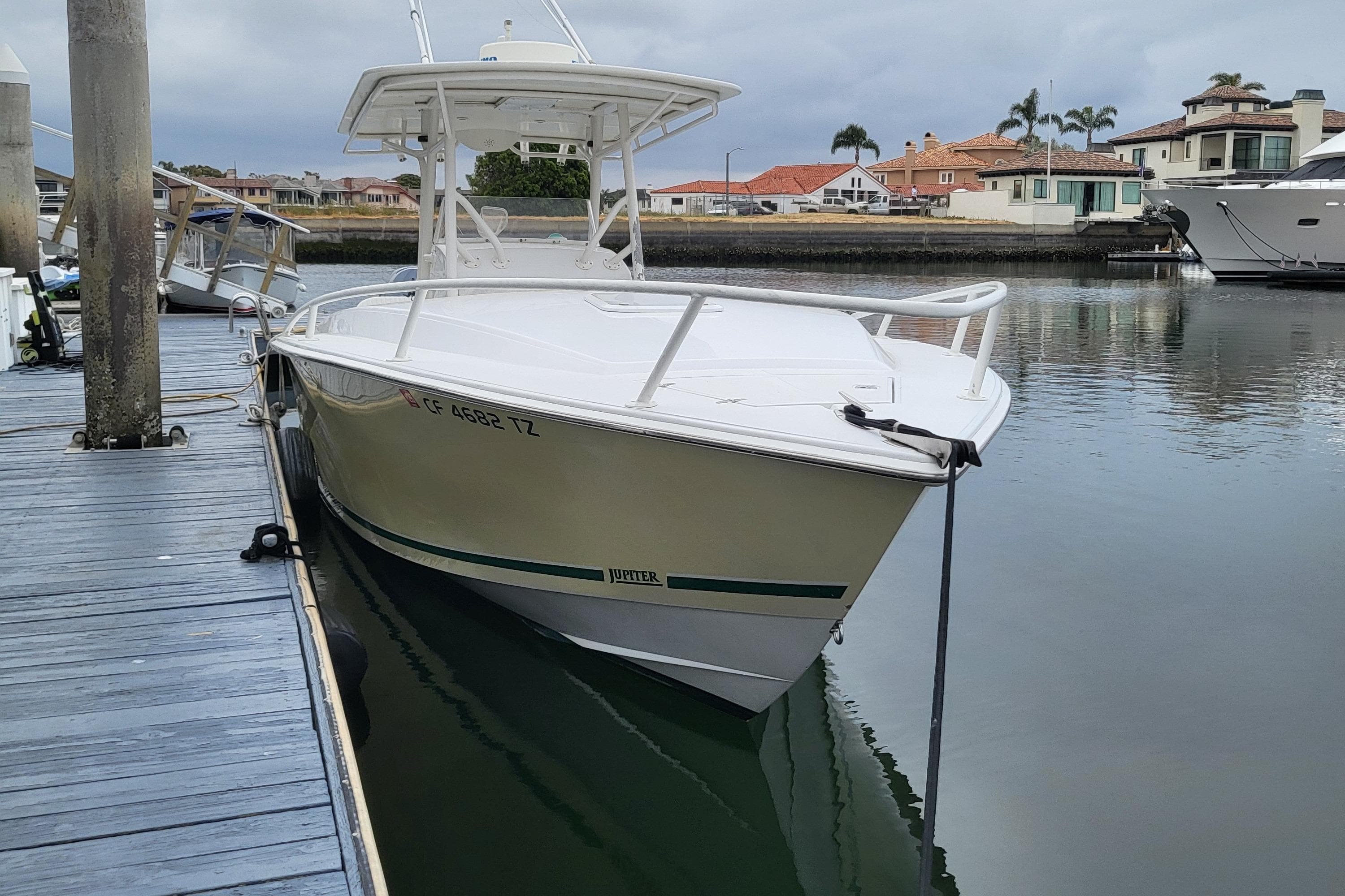 2004 Jupiter 31 Center Console boat docked.