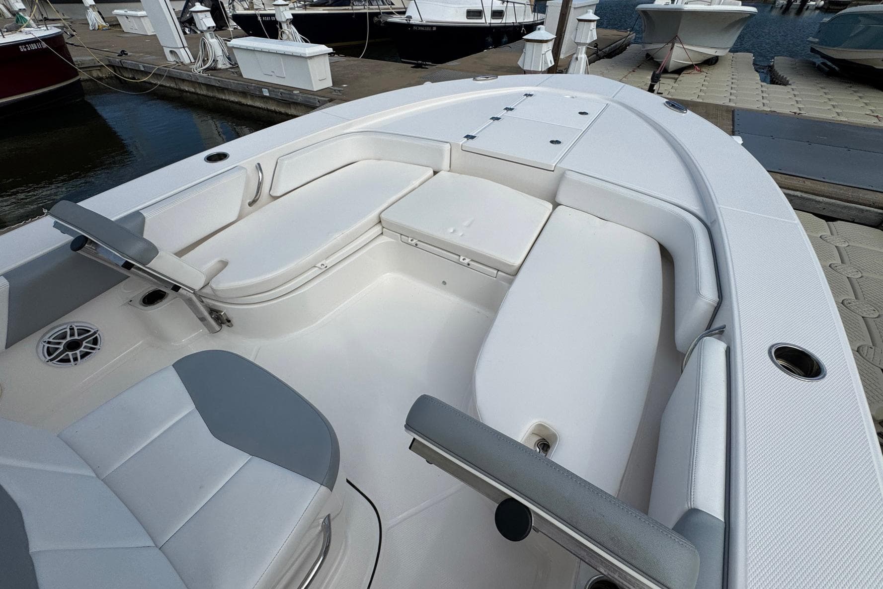 2021 Robalo 246 Cayman boat interior with white seating and docked at marina.