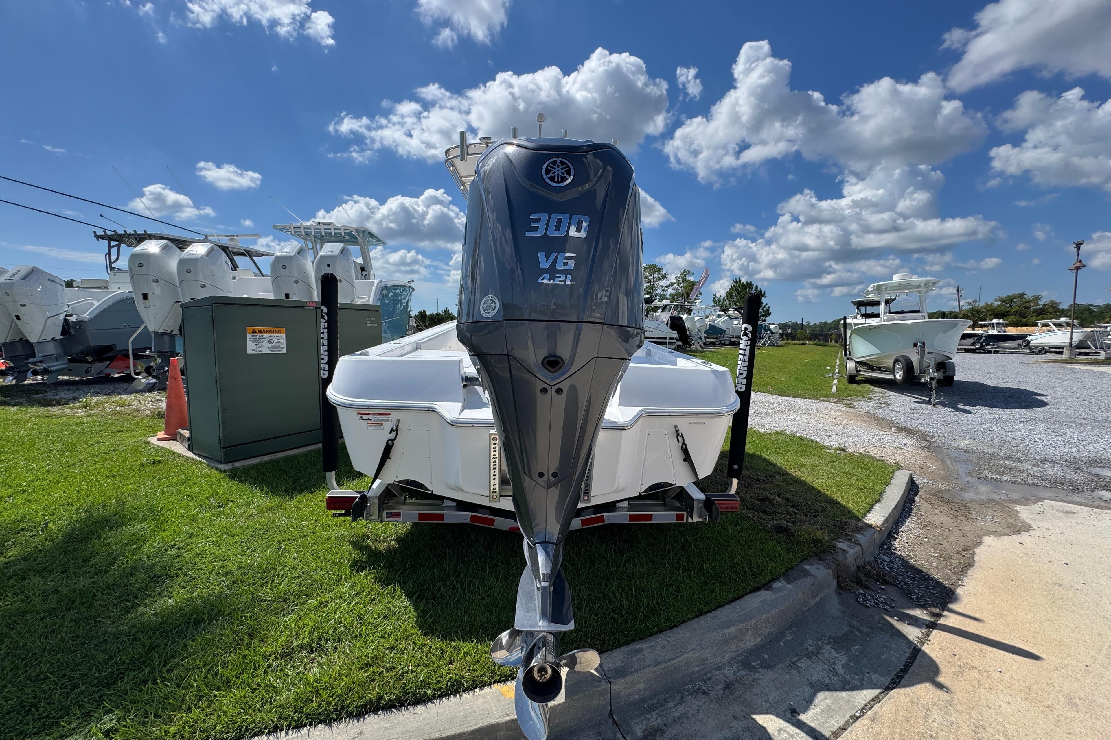 2026 Contender 26 Bay boat with Yamaha 300 V6 engine on a trailer under a blue sky.