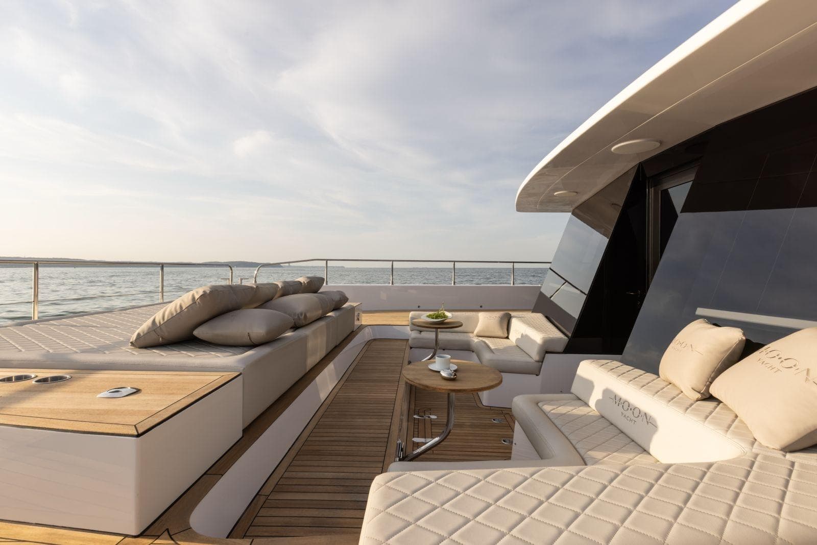 Luxurious 2026 Moon Yachts 6ty deck with elegant seating and ocean view.
