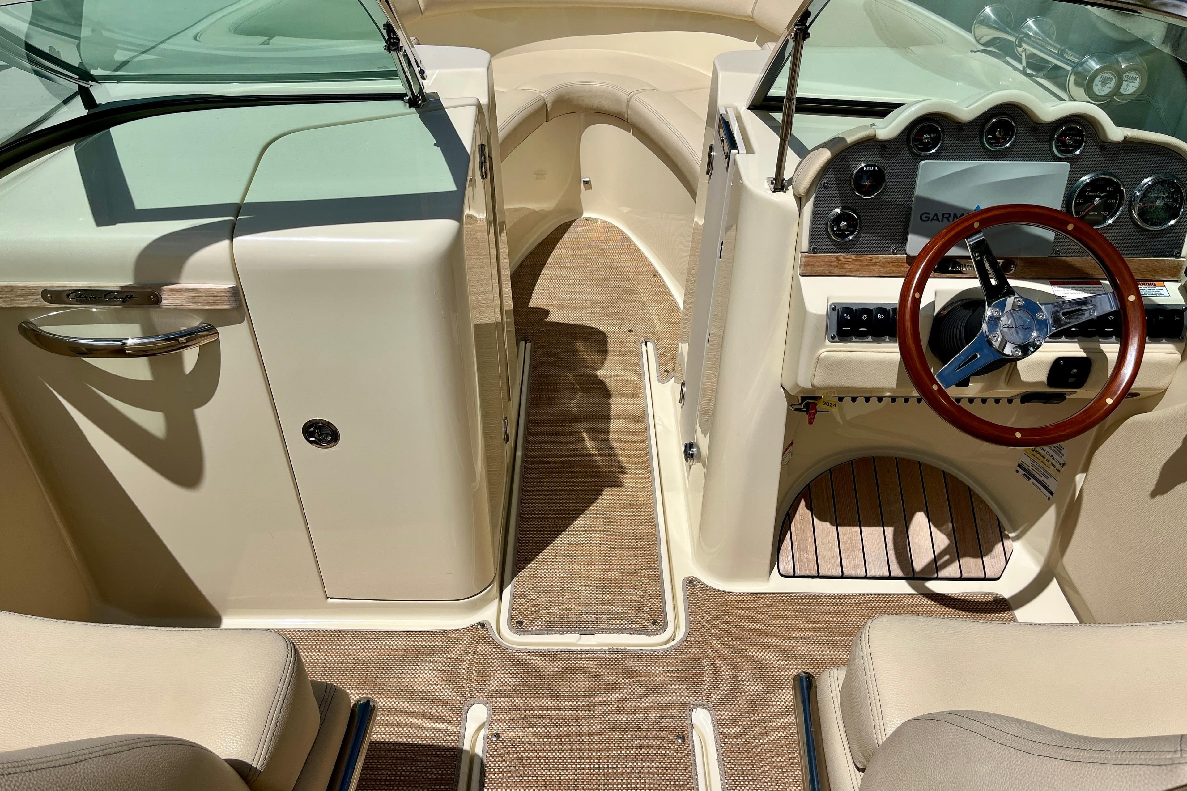 2019 Chris-Craft Launch 27 boat interior with steering wheel and dashboard.